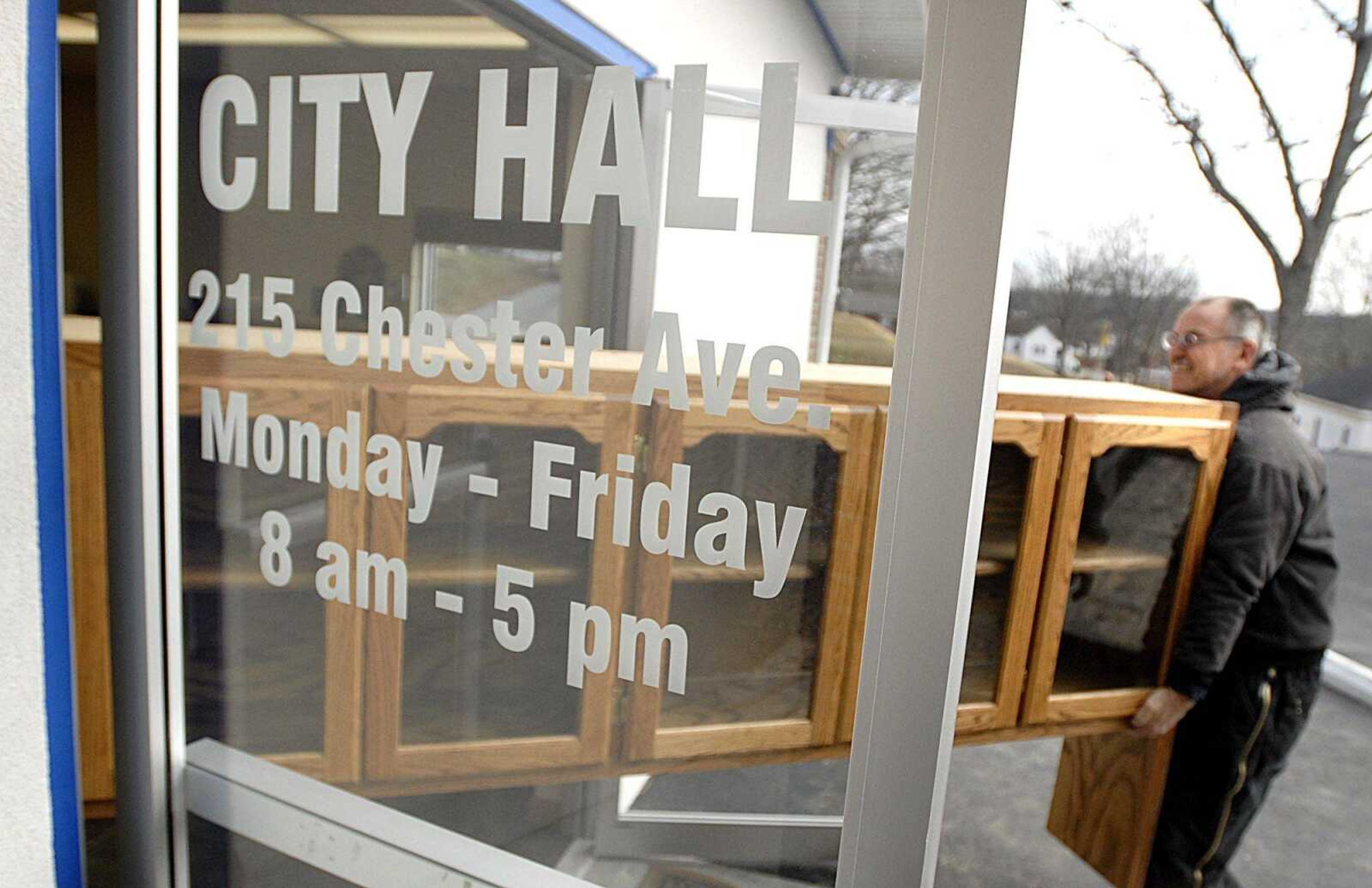 Wayne Rhymer, a Scott City public works employee, supported one end of a cabinet as it was moved Friday into the new city hall building at 215 Chester St. (Aaron Eisenhauer)