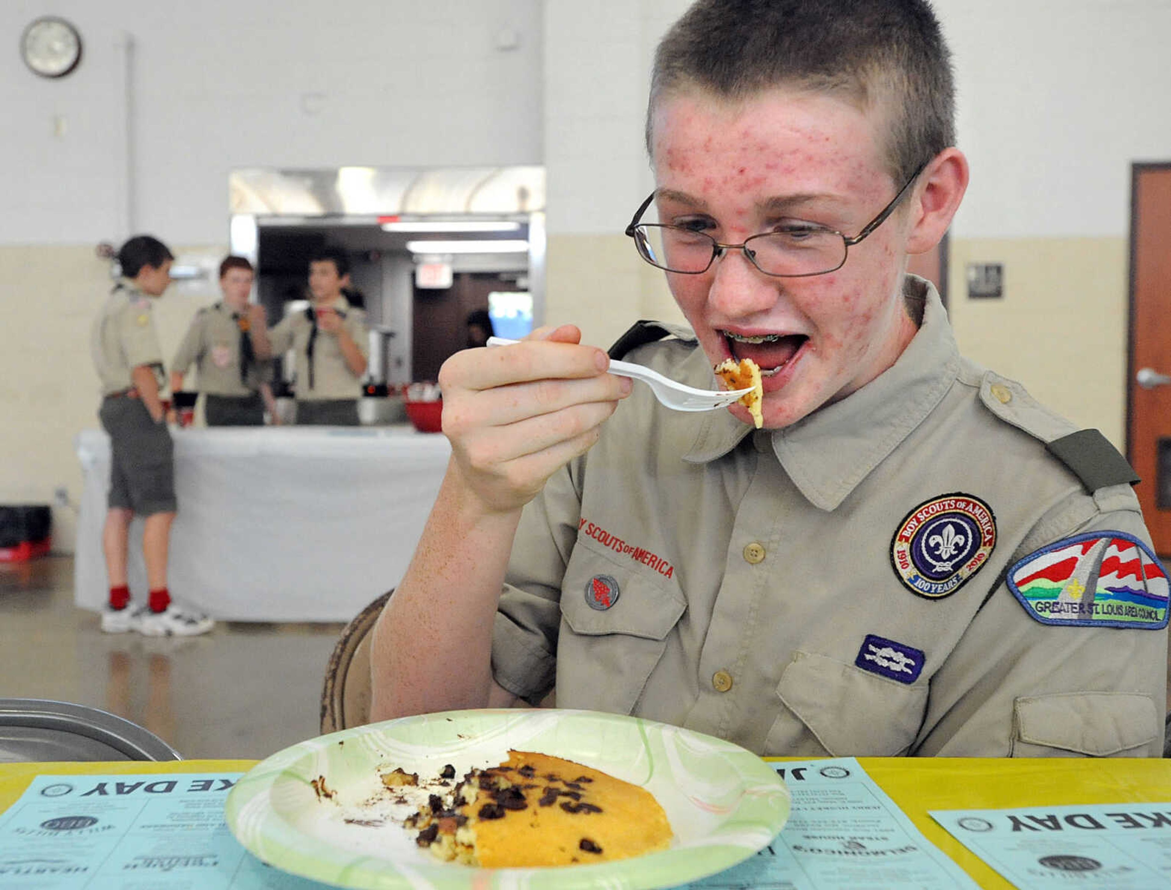 LAURA SIMON ~ lsimon@semissourian.com
Hunter Yates of Boy Scout troop 11 takes a pancake break from volunteering Tuesday, Oct. 23, 2012 during the Jackson Rotary Pancake Day at the National Guard Armory. People could pick from plain, chocolate chip, pecan and blueberry pancakes and a side of sausage.