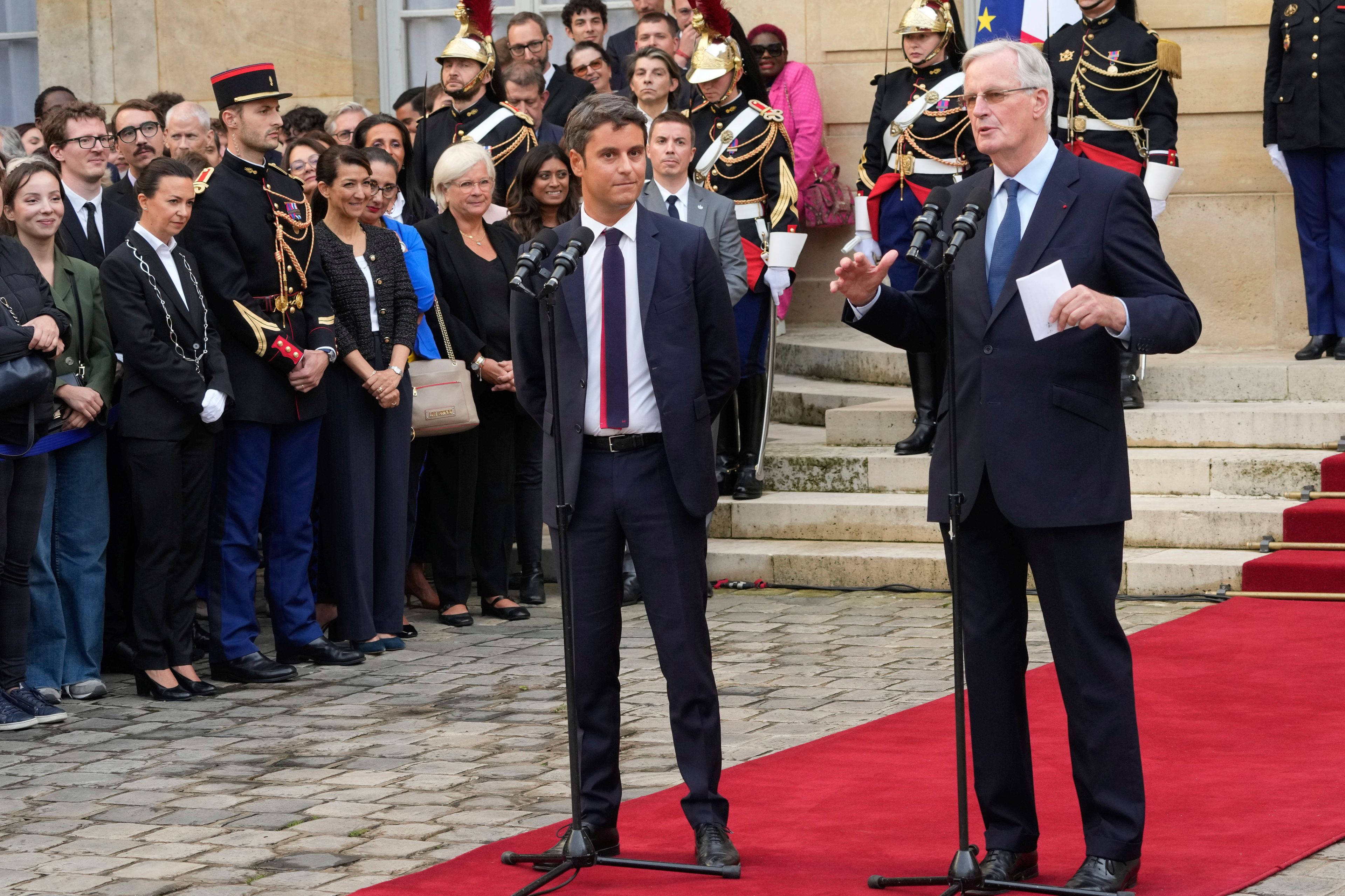 New French prime minister Michel Barnier, right, and outgoing prime minister Gabriel Attal deliver a speech during the handover ceremony, Thursday, Sept. 5, 2024 in Paris. President Emmanuel Macron has named EU's Brexit negotiator Michel Barnier as France's new prime minister after more than 50 days of caretaker government. (AP Photo/Michel Euler)