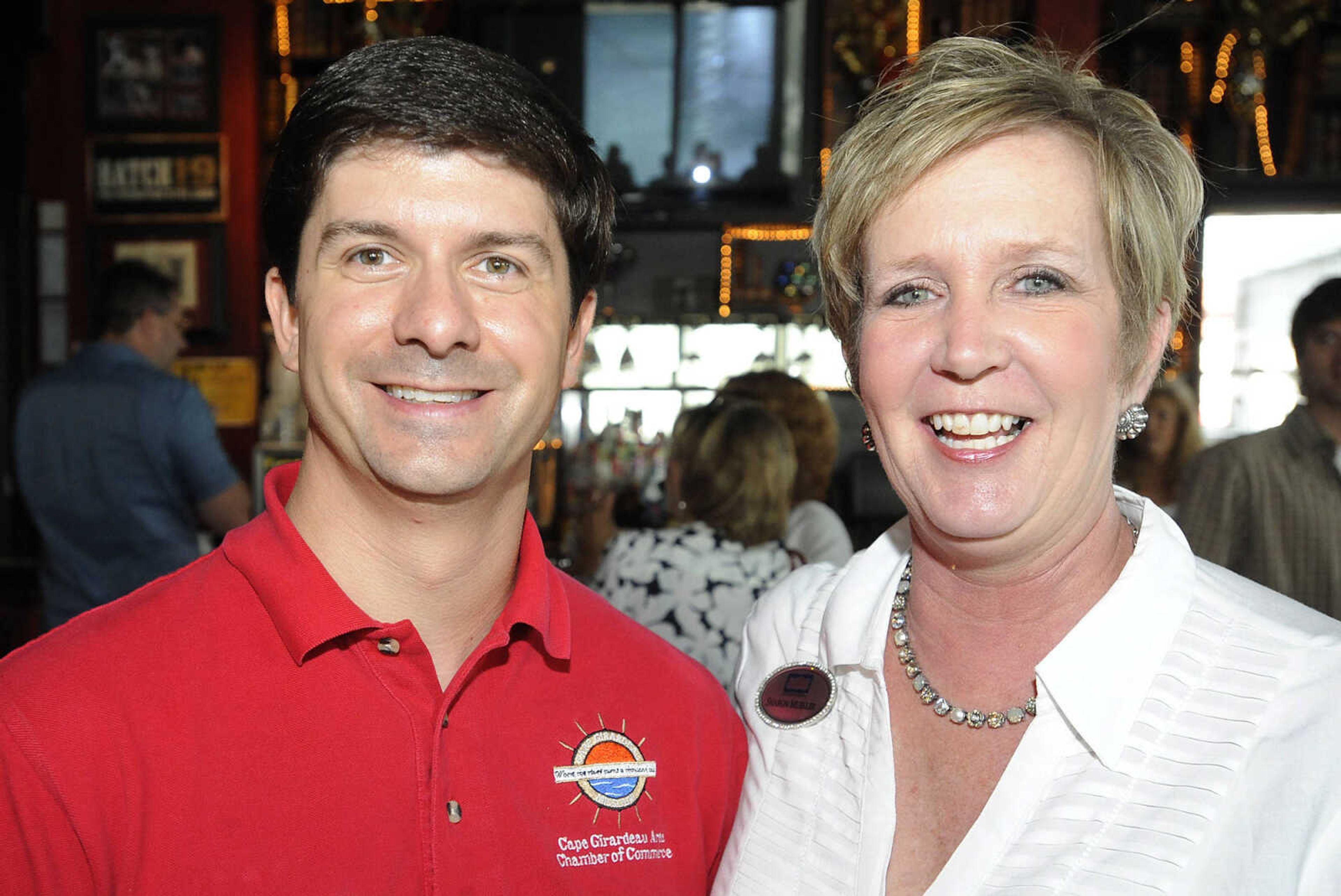 Tim Arbeiter, of the Cape Girardeau Chamber of Commerce, left, Sharon Mueller, of Realty Executives of Cape County, during the Cape Girardeau Area Chamber of Commerce Business After Hours Tuesday, June 18, at The Library, 10 South Spanish St., in Cape Girardeau.