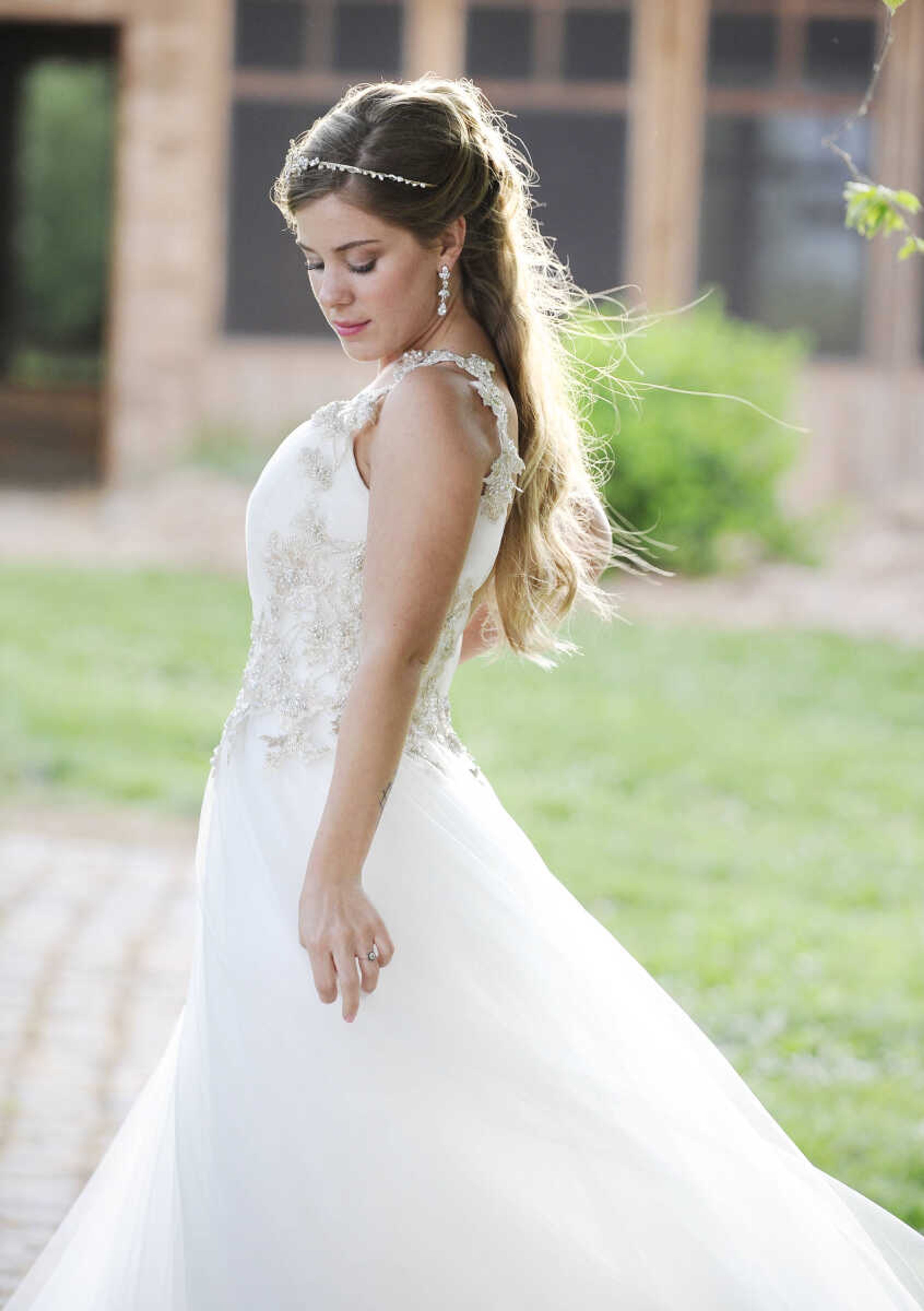 LAURA SIMON ~ lsimon@semissourian.com

On Lydia: This ivory Maggie Sottero "Shelby" gown features a pleated tulle A-line skirt and fitted bodice adorned with Swarovski crystals and floral-inspired lace appliques at the waist and shoulders. The dress has a plunging V-neckline and back with a zipper closure. Available at J Marie's Formal Affairs in Chaffee, Missouri.