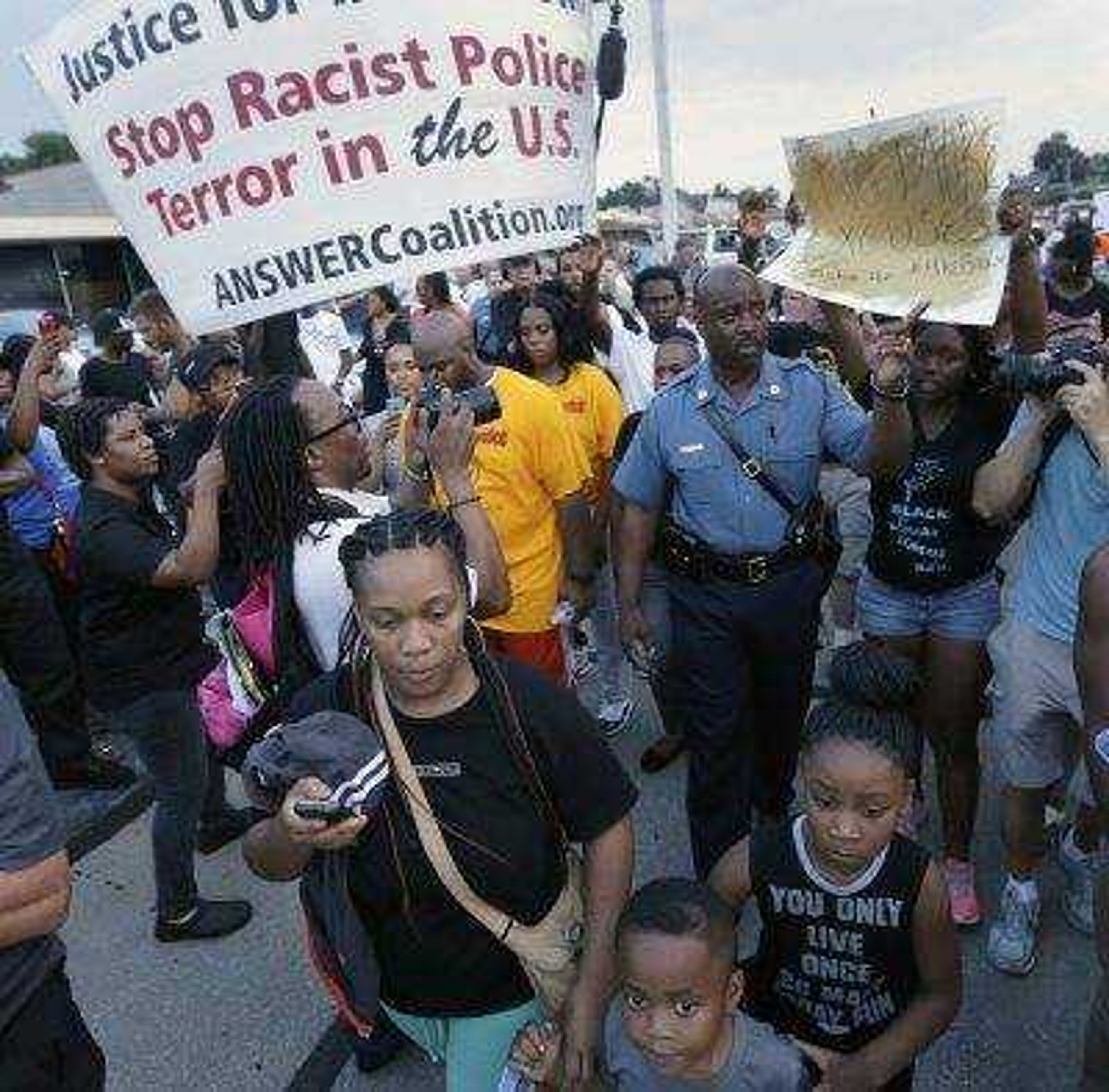 Missouri State Highway Patrol Capt. Ron Johnson on Aug. 16 walks among people protesting the police shooting death of Michael Brown in Ferguson, Missouri.