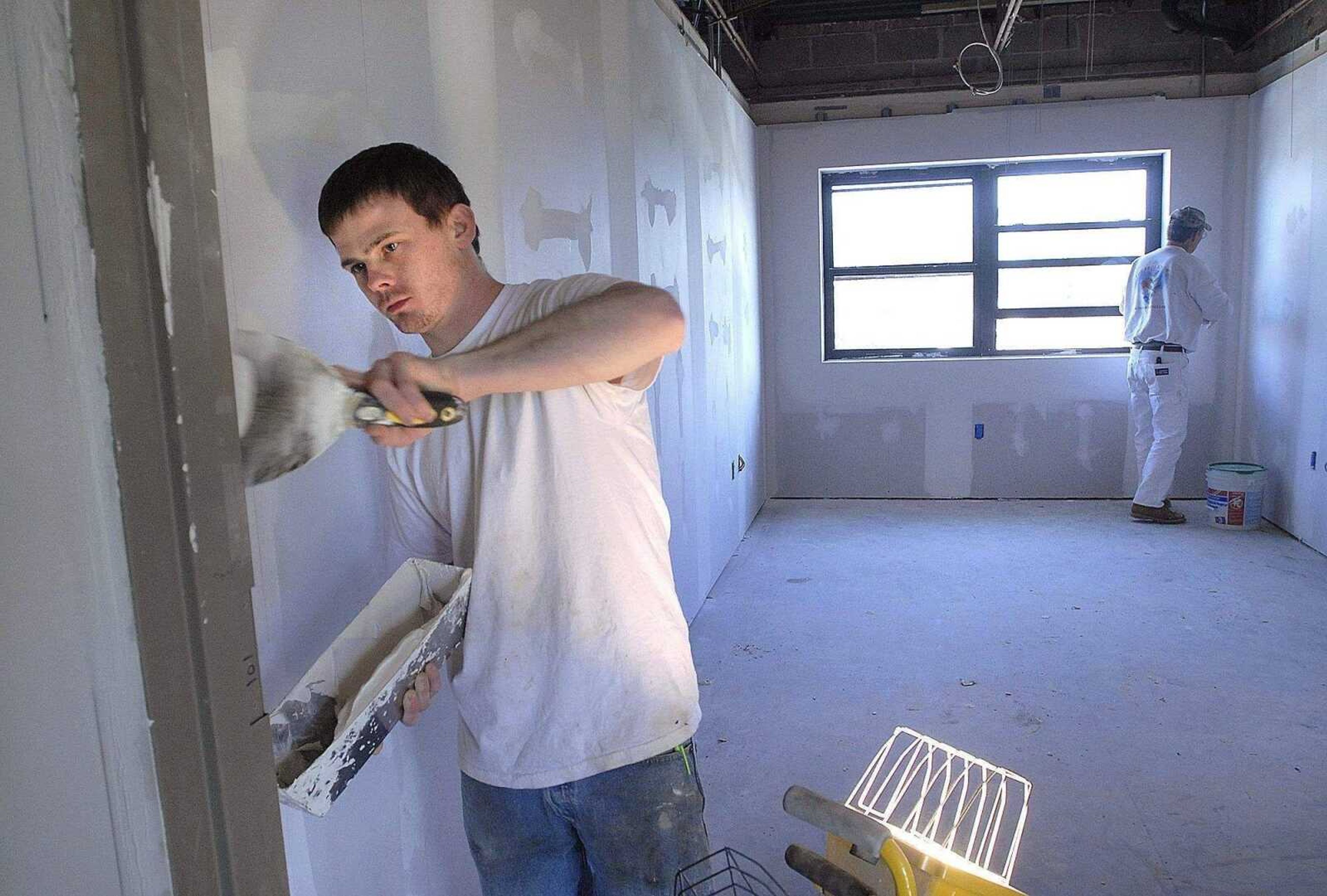 FRED LYNCH ~ flynch@semissourian.com<br>Keith Benton, left, and Dean Benton with Precision Painting work with drywall in an office that is being refurbished Monday at the Missouri Army National Guard armory in Cape Girardeau.