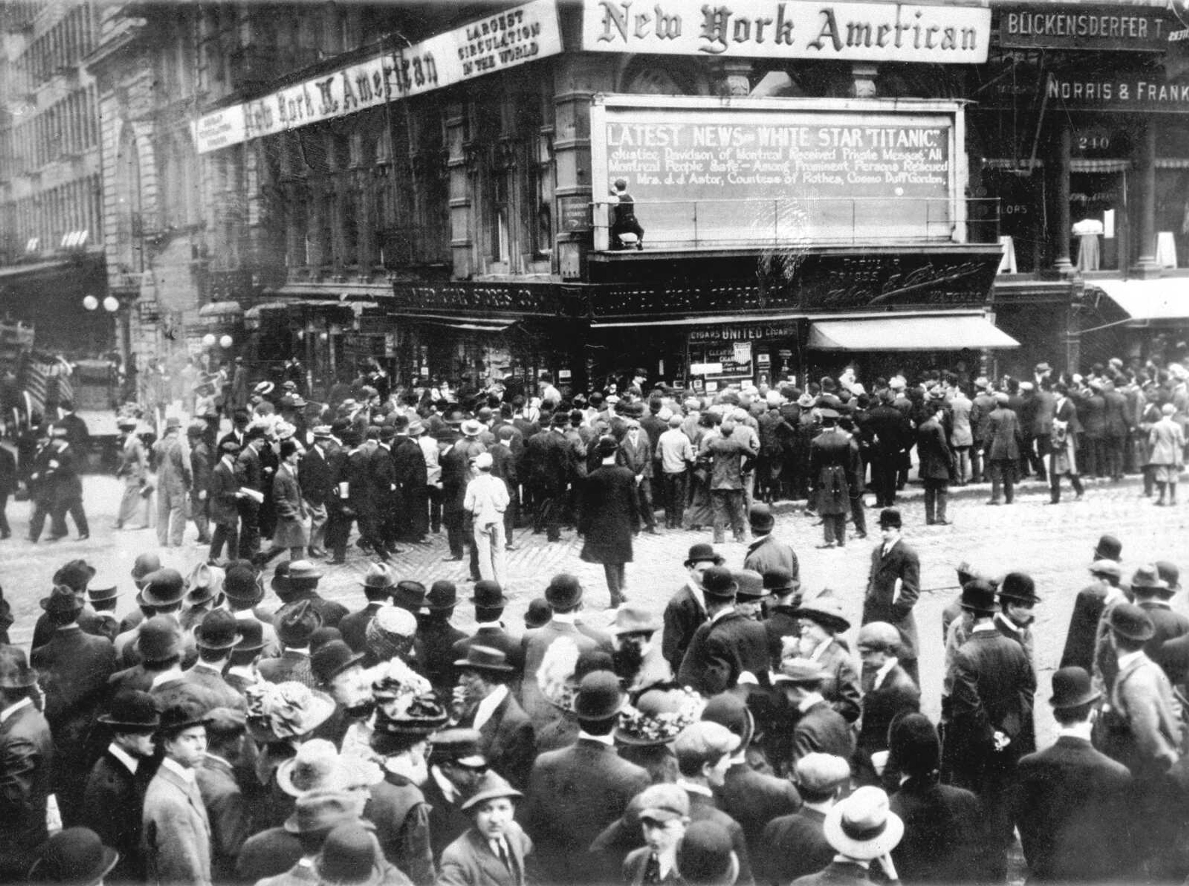 Crowds gather in April 1912 around the bulletin board of the New York American newspaper in New York, where the names of people rescued from the Titanic are displayed. (Associated Press file)