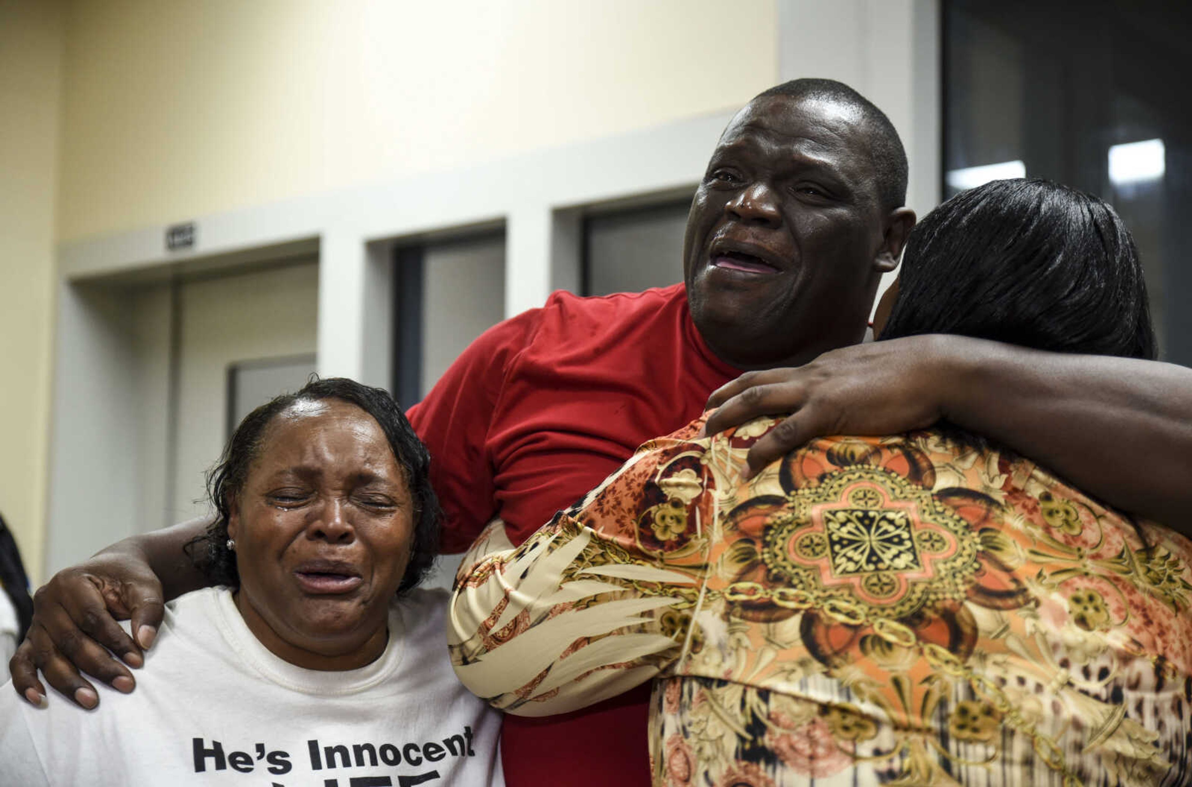 From left, Jennett McCaster, David Robinson and Pat Jackson embrace after Robinson's release from the Jefferson City Correctional facility Monday, May 14, 2018 in Jefferson City.