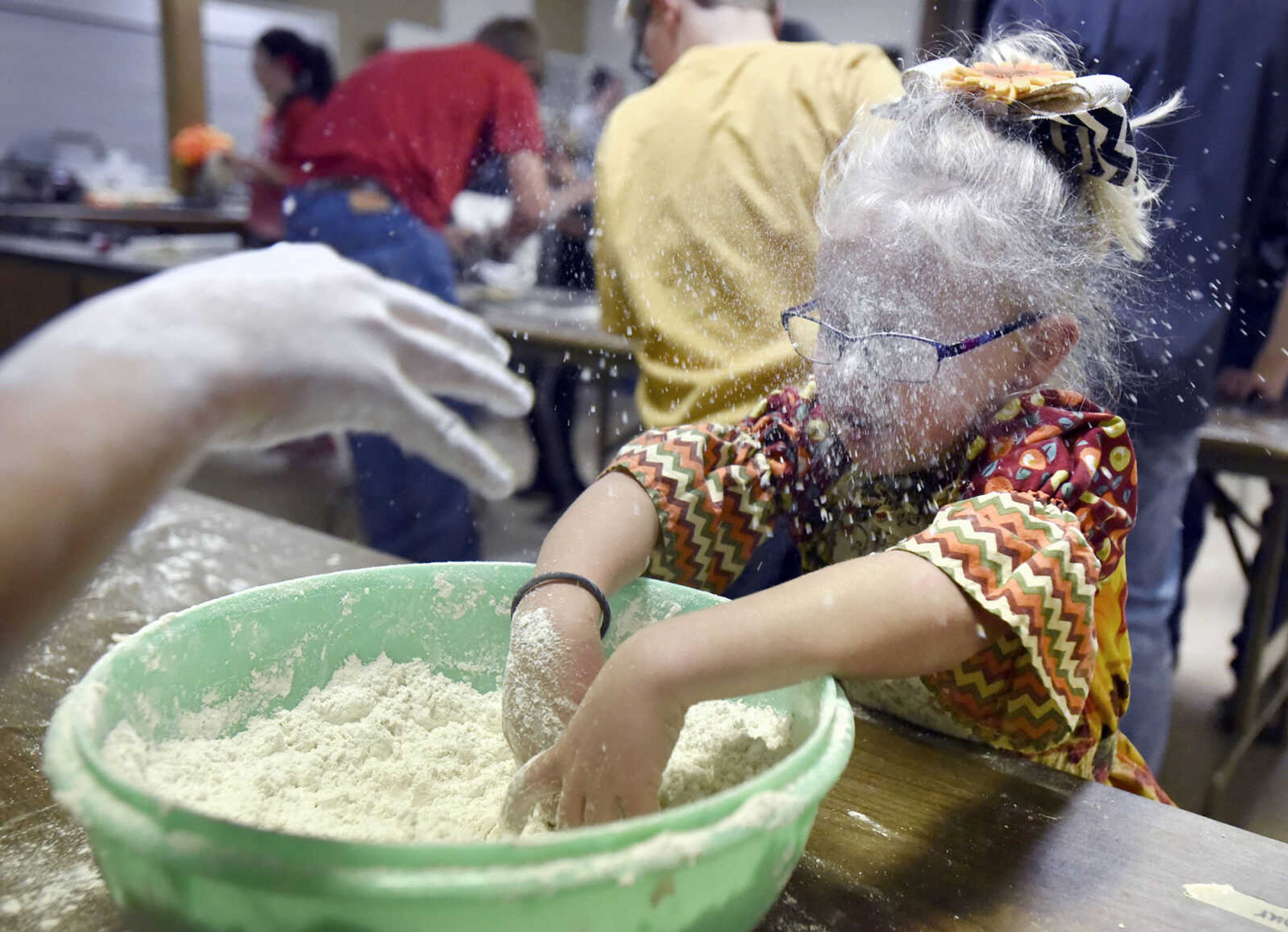 LAURA SIMON ~ lsimon@semissourian.com

Autumn McBryde dusts her sister Liza with leftover flour on Tuesday, Nov. 22, 2016, at Emanuel United Church of Christ in Jackson. Youth members of Jackson's Progressive 4-H Club made over 100 pies for the Salvation Army Thanksgiving dinner.