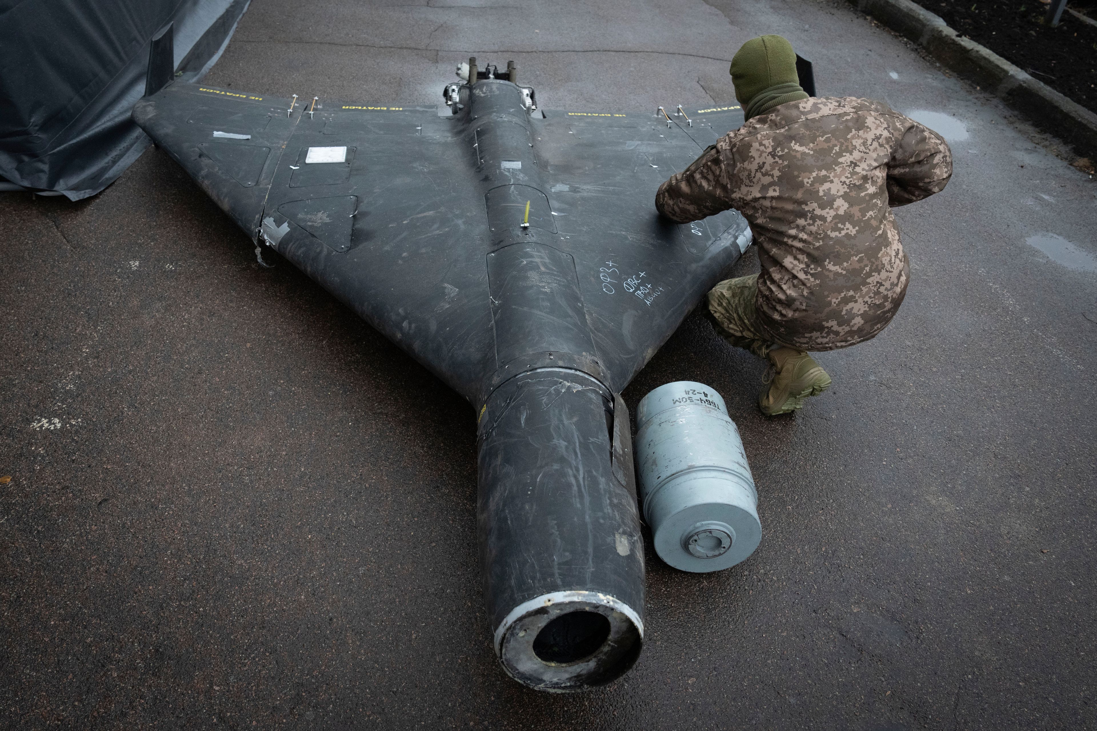 A Ukrainian officer examines a downed Shahed drone with thermobaric charge launched by Russia in a research laboratory in an undisclosed location in Ukraine Thursday, Nov. 14, 2024. (AP Photo/Efrem Lukatsky)