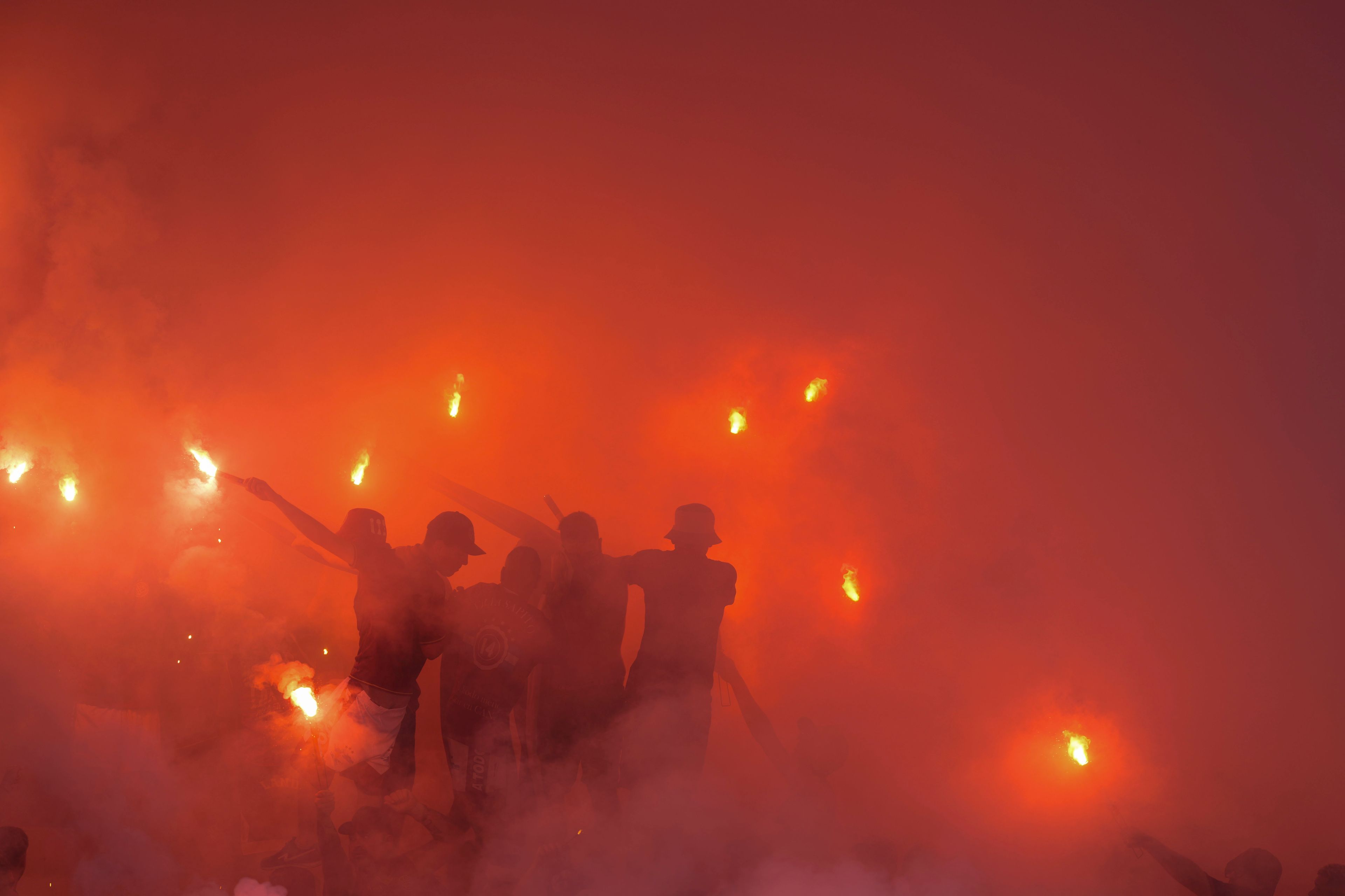 Fans of Argentina's Lanus launch fireworks before the start of a Copa Sudamericana semifinal second leg soccer match against Brazil's Cruzeiro at La Fortaleza Stadium in Buenos Aires, Argentina, Wednesday, Oct. 30, 2024. (AP Photo/Natacha Pisarenko)