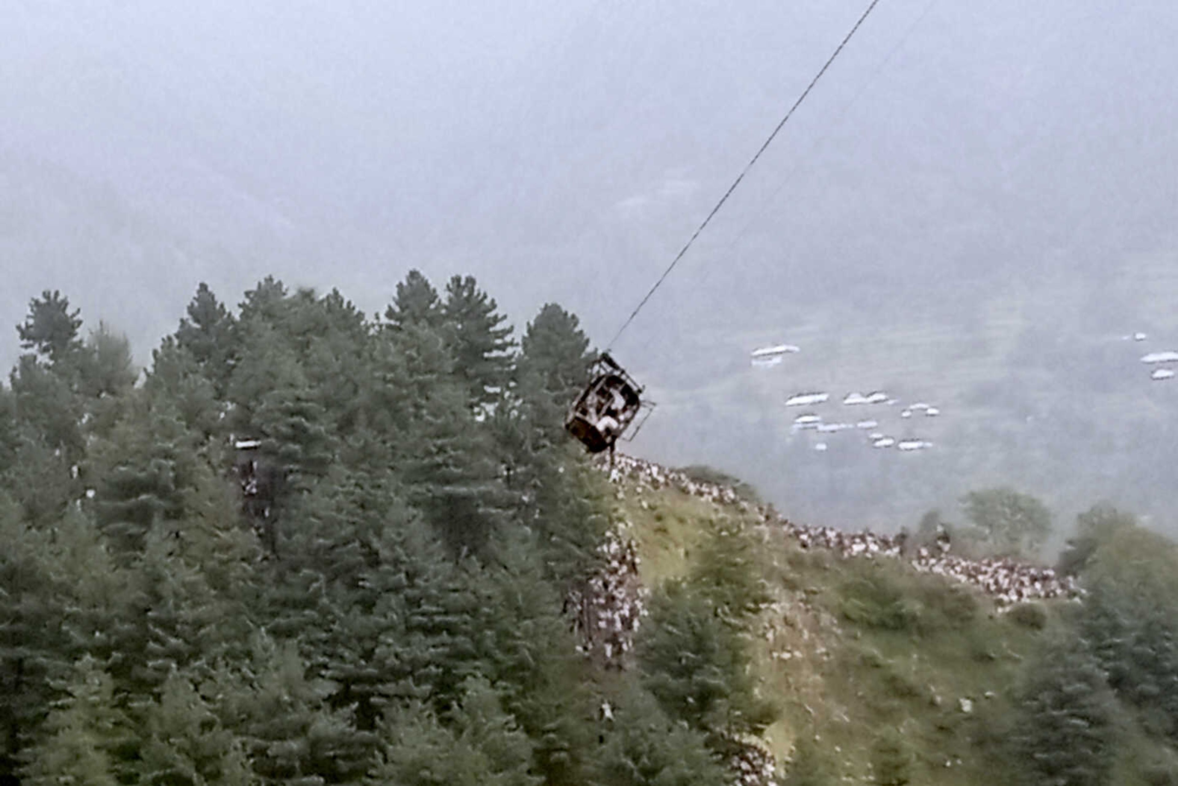 A cable car carrying eight people dangles hundreds of meters above the ground Tuesday in Pashto village, a mountainous area of Battagram district in Pakistan's Khyber Pakhtunkhwa province.