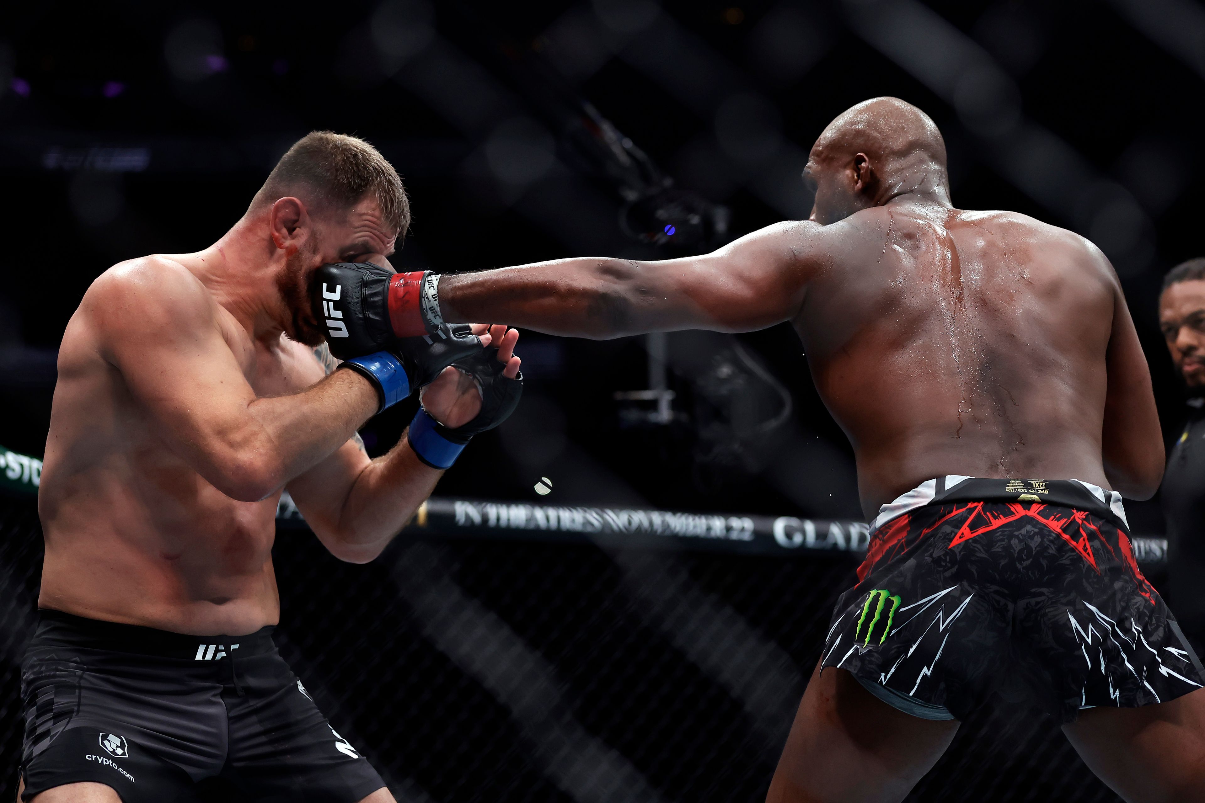 Jon Jones, right, punches Stipe Miocic in a UFC 309 mixed martial arts heavyweight title bout, early on Sunday, Nov. 17, 2024, in New York. (AP Photo/Adam Hunger)