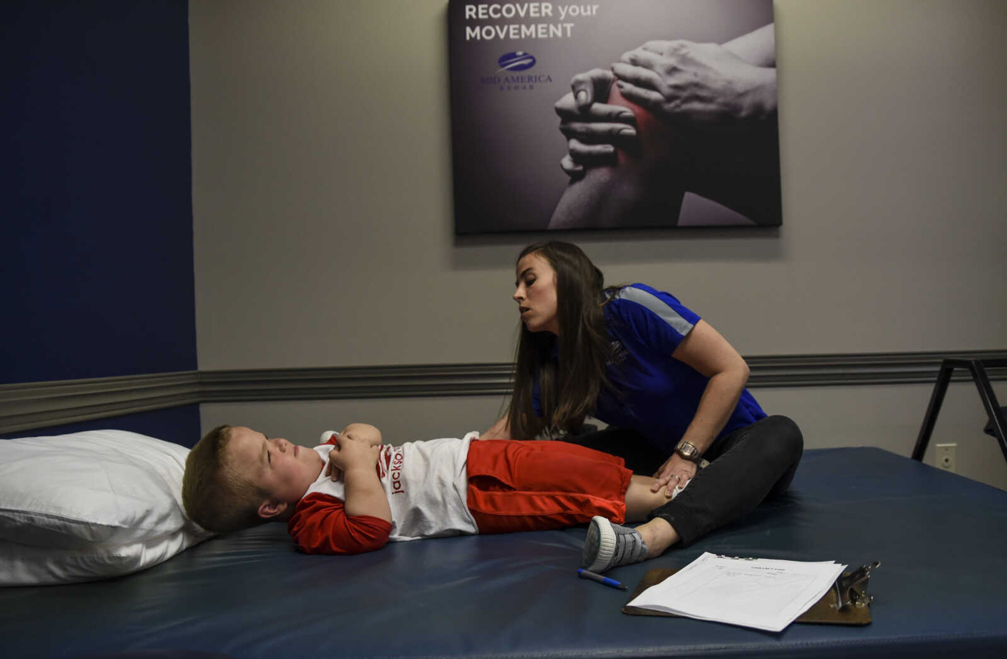 Izaac Pursley works with physical therapist Katie Schaal during his first physical therapy session at Mid America Rehab May 1, 2018, in Cape Girardeau.