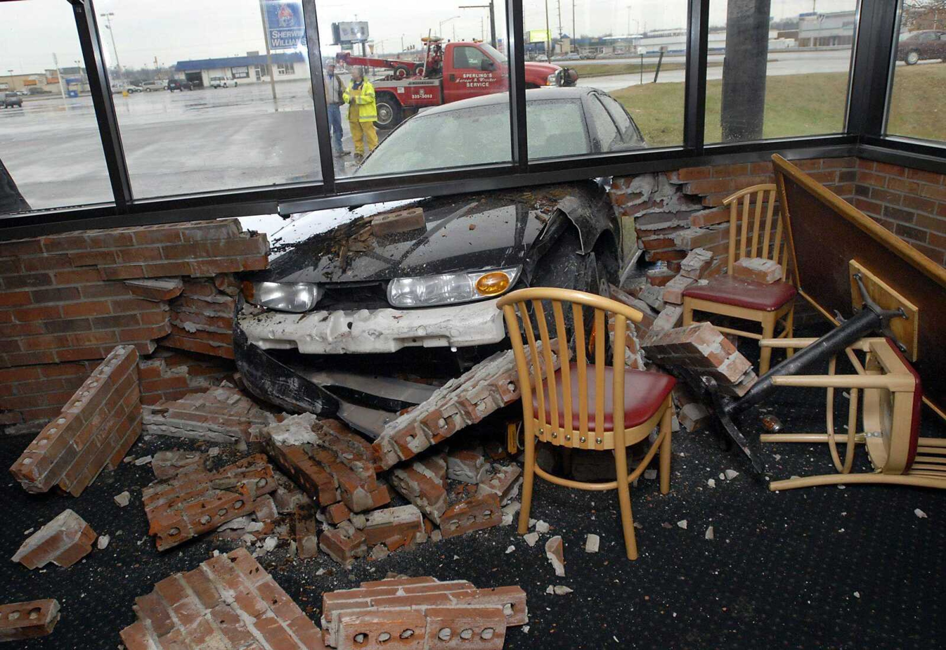 The solarium dining area at Pizza Hut on South Kingshighway lies in disarray after the driver of a 2001 Saturn lost control and crashed through the wall on Friday, March 3, 2011. (Kristin Eberts)