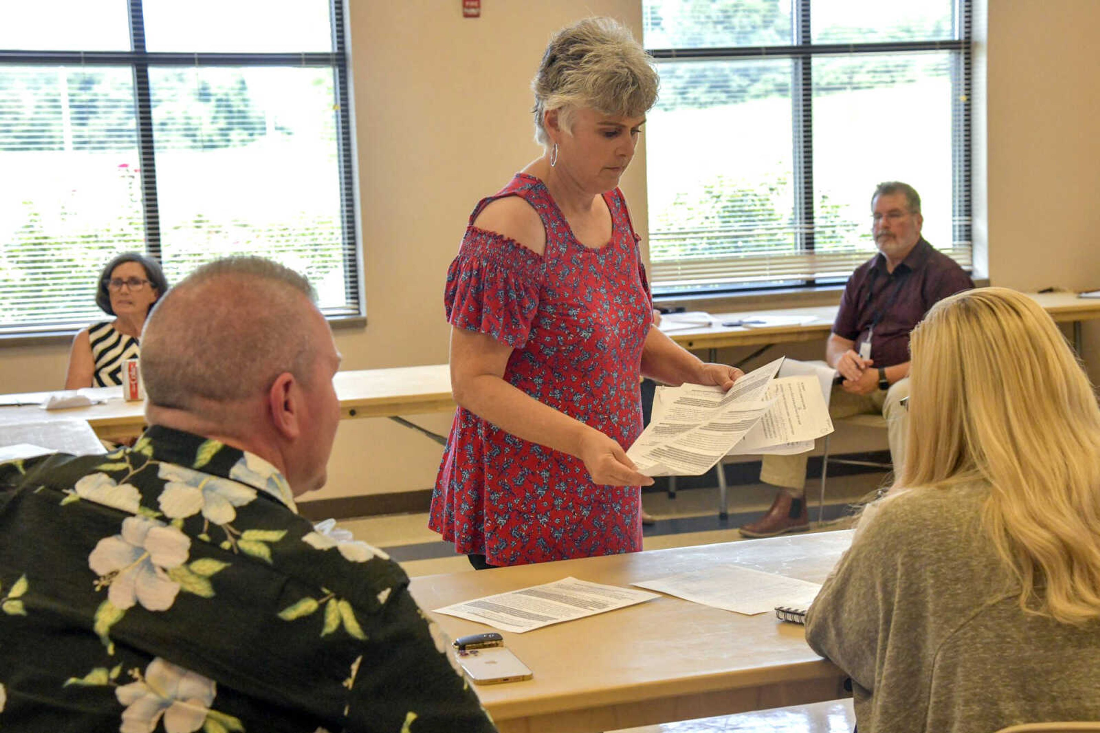 Rita LaVanchy gives board members a copy of her emails that she sent to certain board members about her concerns, and she later expressed her thoughts on their responses during a Cape Girardeau County Public Health Center board meeting Tuesday at Shawnee Park Center in Cape Girardeau.