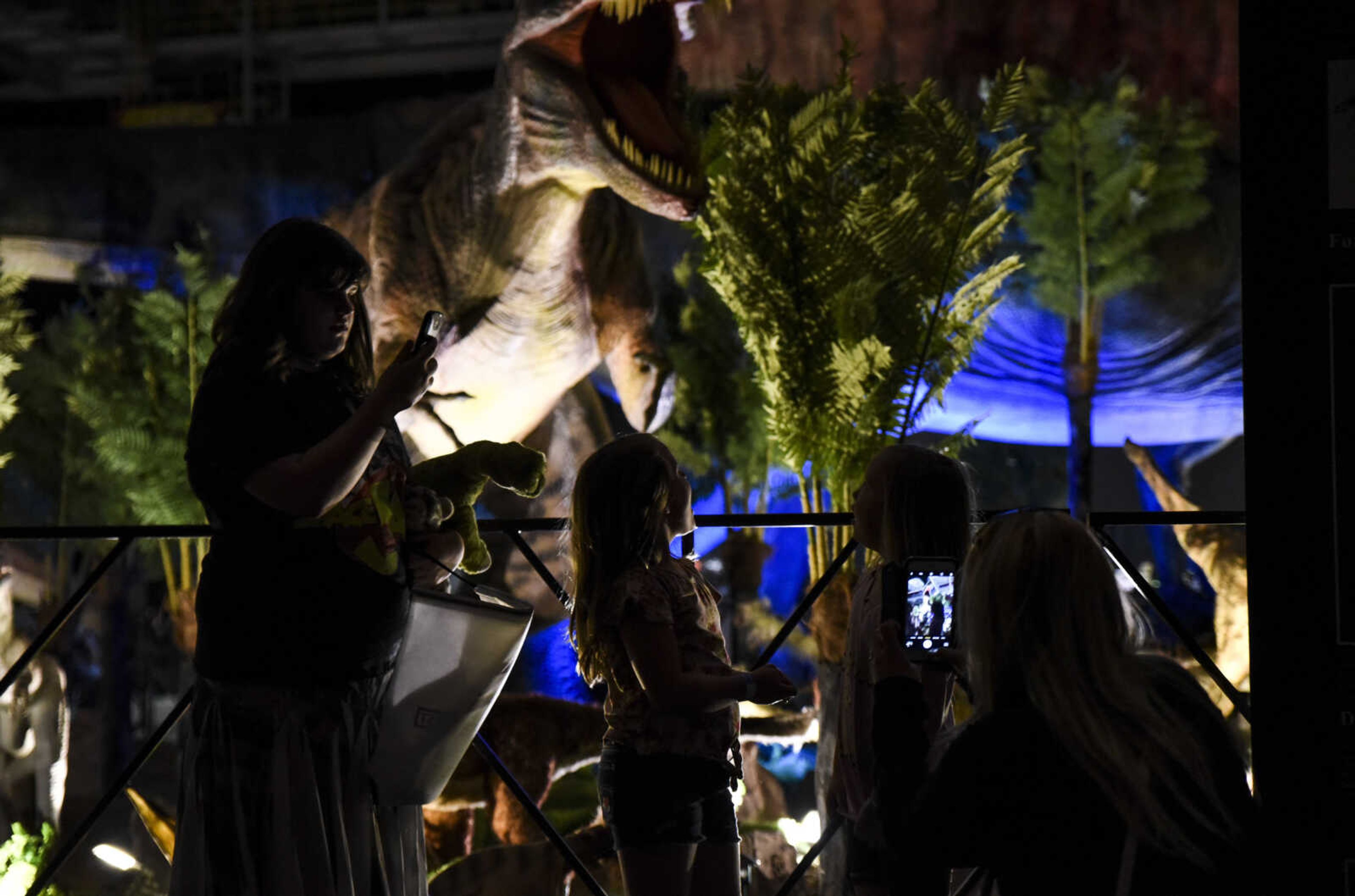 Jill Sutton photographs Peyton Sutton, center, 7, and Addison Shrum, 6, right, while Regan Priday, left, 12, stands by at Jurassic Quest Friday, April 27, 2018, at the Show Me Center in Cape Girardeau.