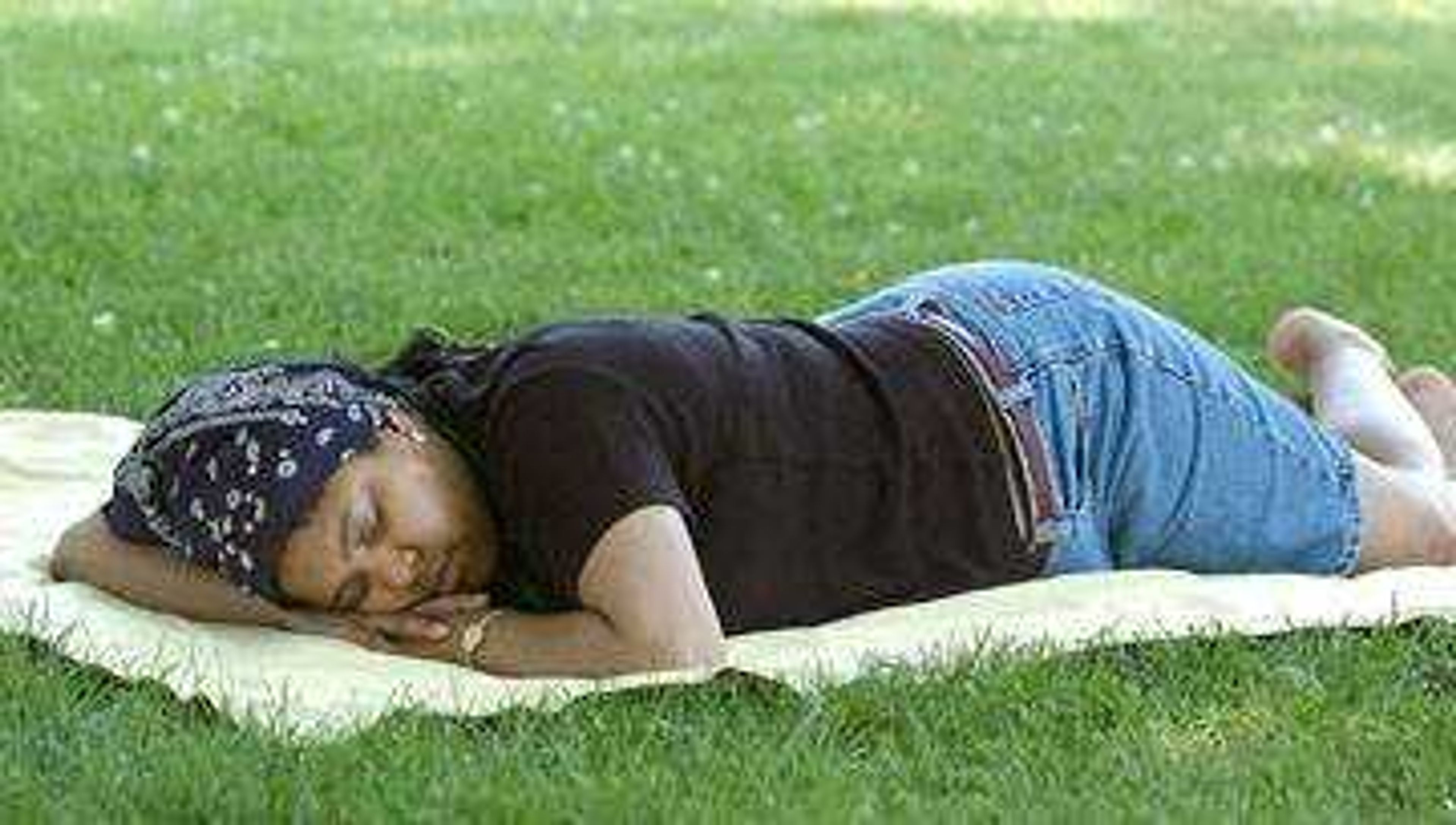 Katherine Grant, a past resident of Cape Girardeau now of Cincinnati, Oh. napped under a shade tree in Capaha Park, Friday, July 4, 2003.