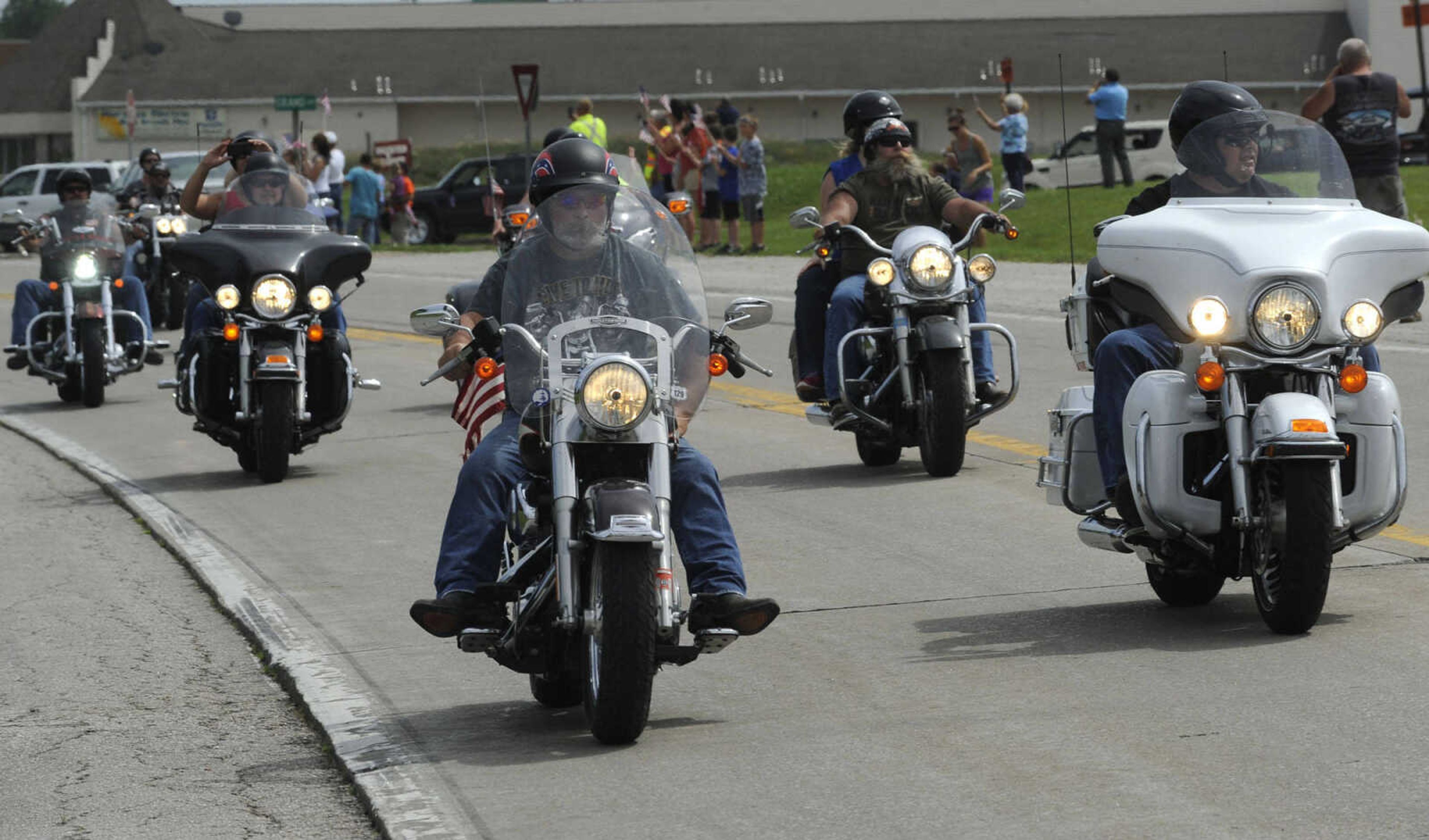 Motorcyclists ride with The Wall That Heals on Tuesday, June 17, 2014 in Perryville, Mo.