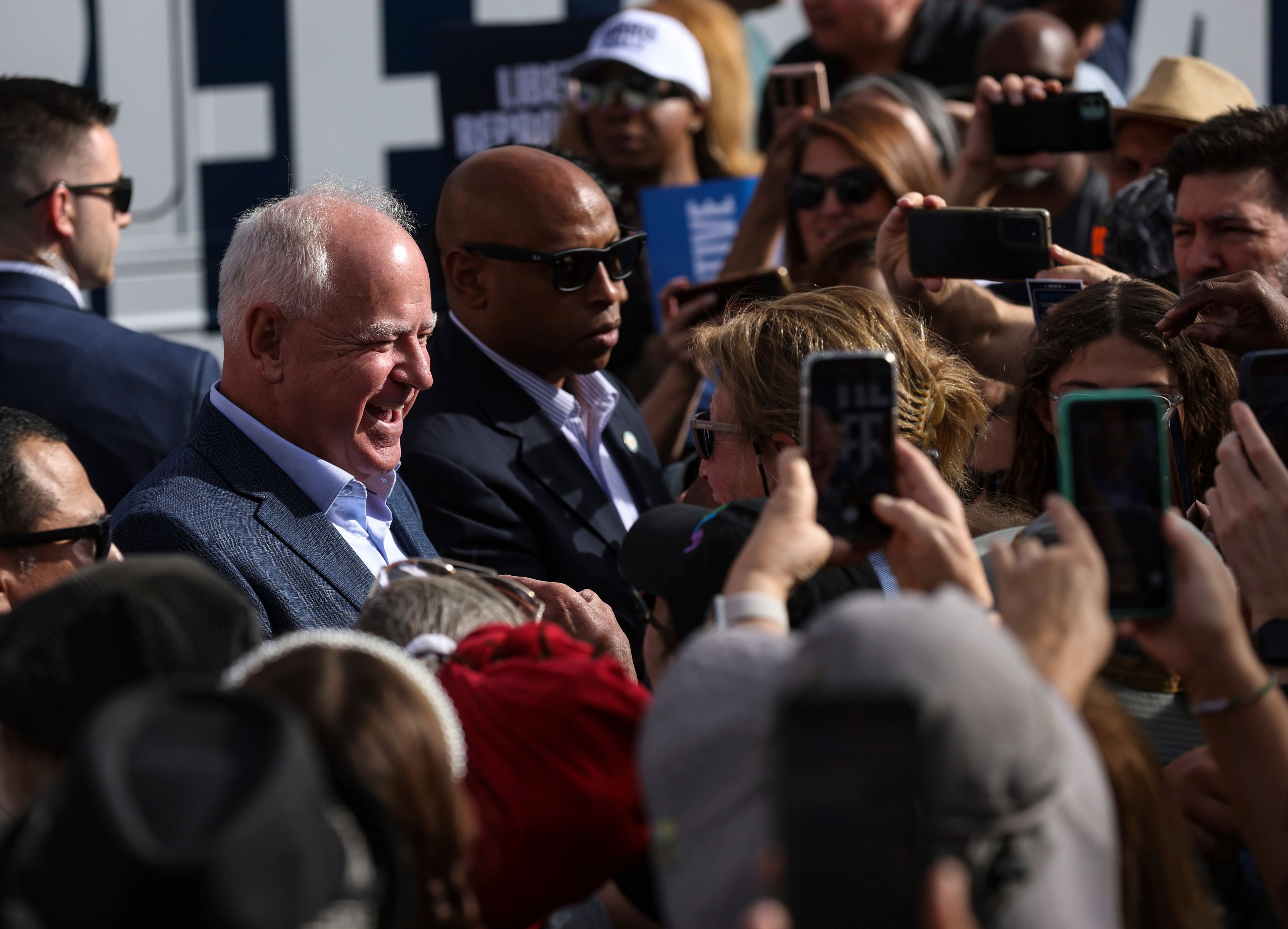 Democratic vice presidential nominee Tim Walz greets members of the crowd at a Harris-Walz campaign's "Fighting for Reproductive Freedom" bus tour stop and canvass kick-off event outside their campaign office in Henderson, Sunday, Oct. 27, 2024. (Rachel Aston/Las Vegas Review-Journal via AP)