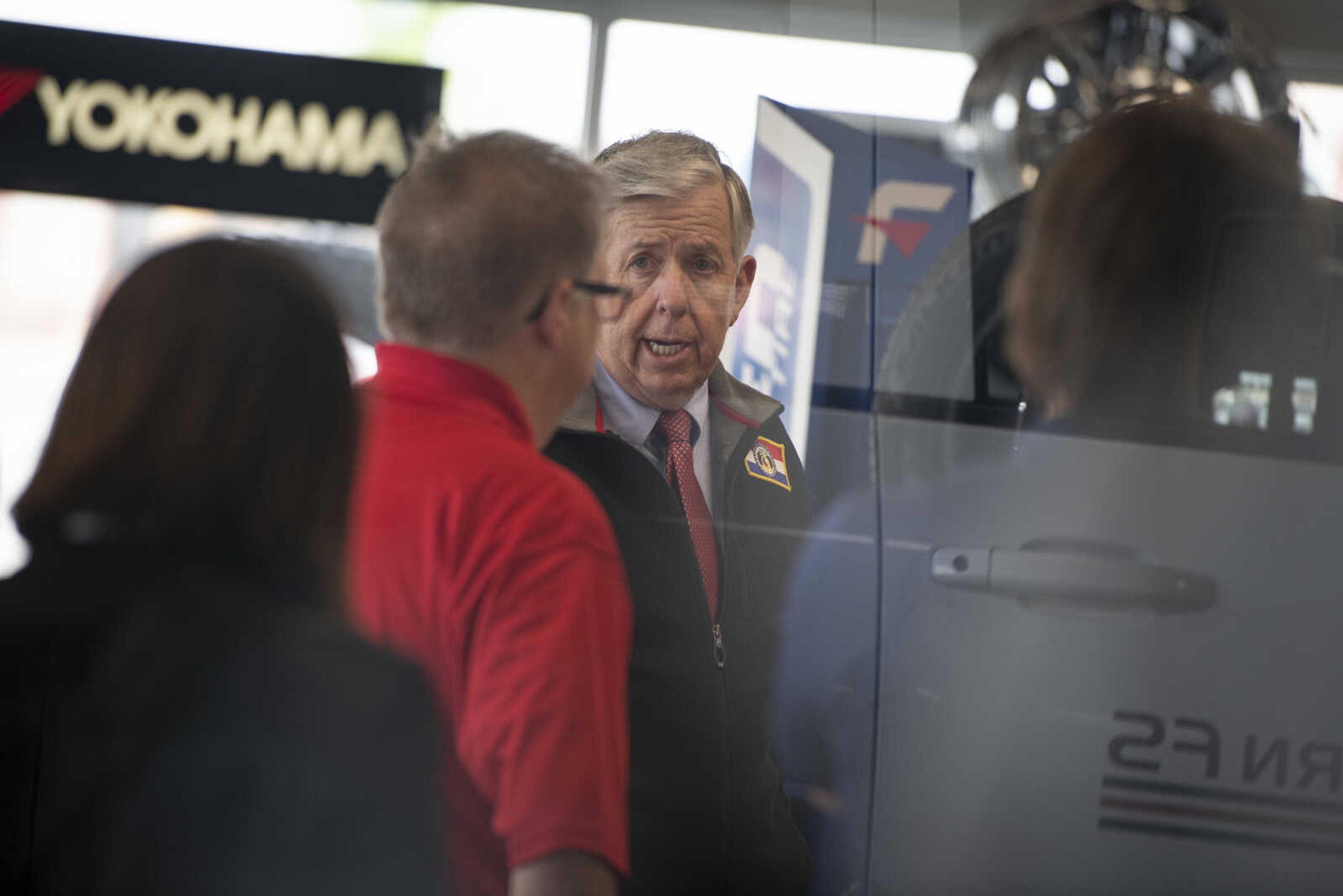 Missouri Gov. Mike Parson, center, speaks while making a visit Thursday, May 14, 2020, at Plaza Tire Service at 170 S. Kingshighway in Cape Girardeau.