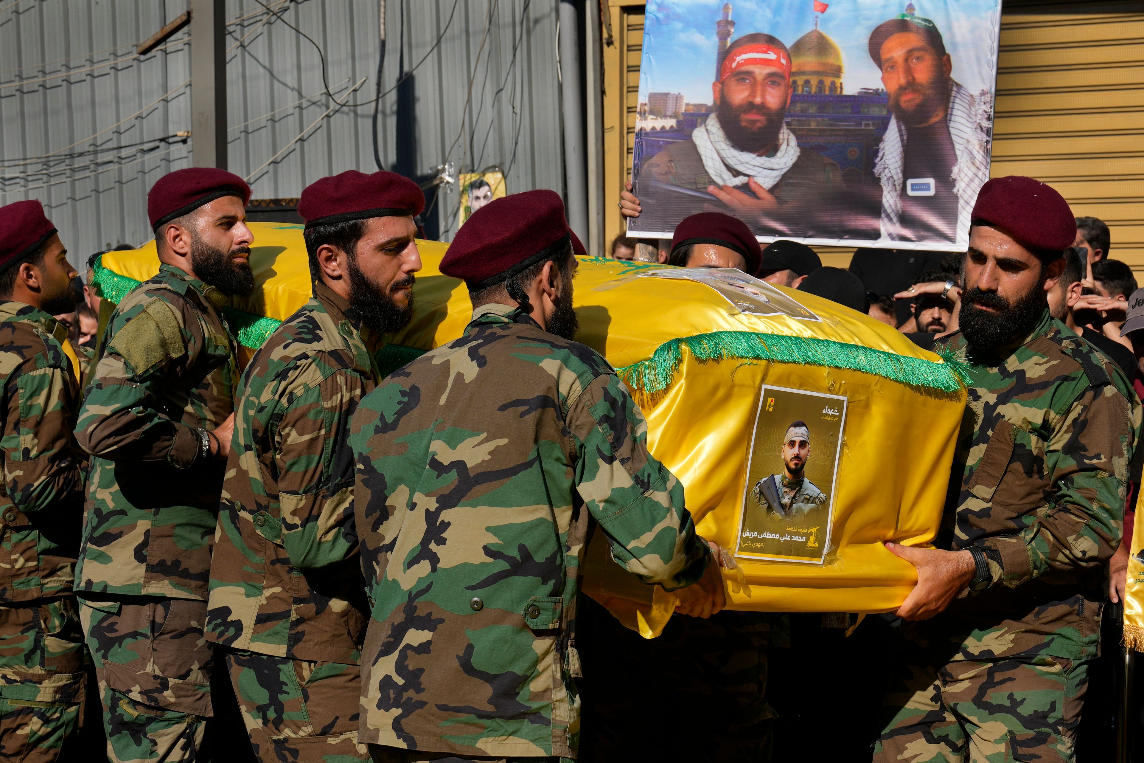 Hezbollah fighters carry the coffin of their comrade who was killed with three others on Saturday by an Israeli airstrike in south Lebanon, during their funeral procession in the southern suburb of Beirut, Lebanon, Sunday, July 28, 2024. The Middle East braced for a potential flare-up in violence on Sunday after Israeli authorities said a rocket from Lebanon struck a soccer field in the Israeli-controlled Golan Heights, killing 12 children and teens in what the military called the deadliest attack on civilians since Oct. 7. (AP Photo/Hussein Malla)