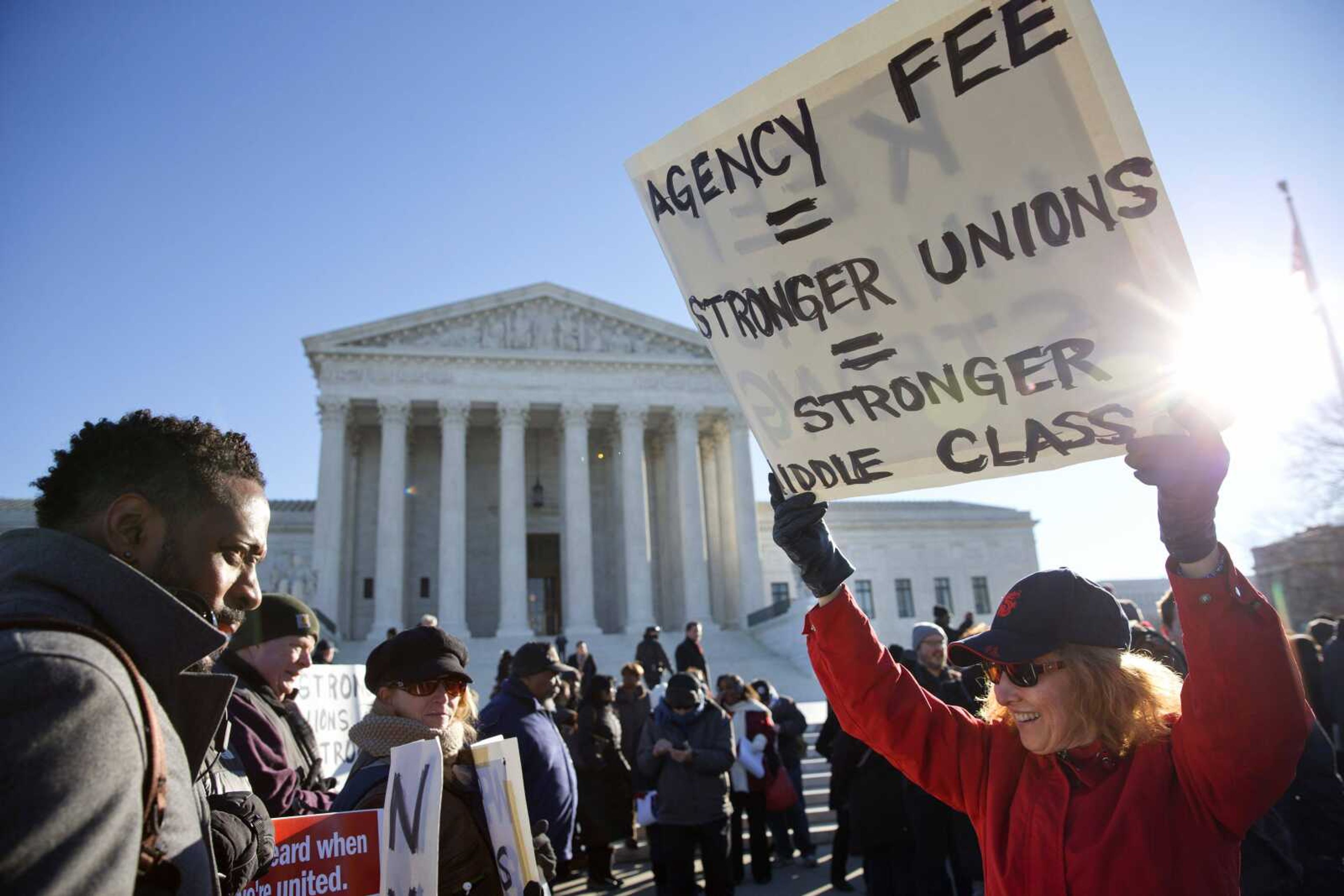 Lesa Curtis, right, of Westchester, New York, rallies Monday outside of the Supreme Court in Washington as the court heard arguments in the Friedrichs v. California Teachers Association case. (Jacquelyn Martin ~ Associated Press)