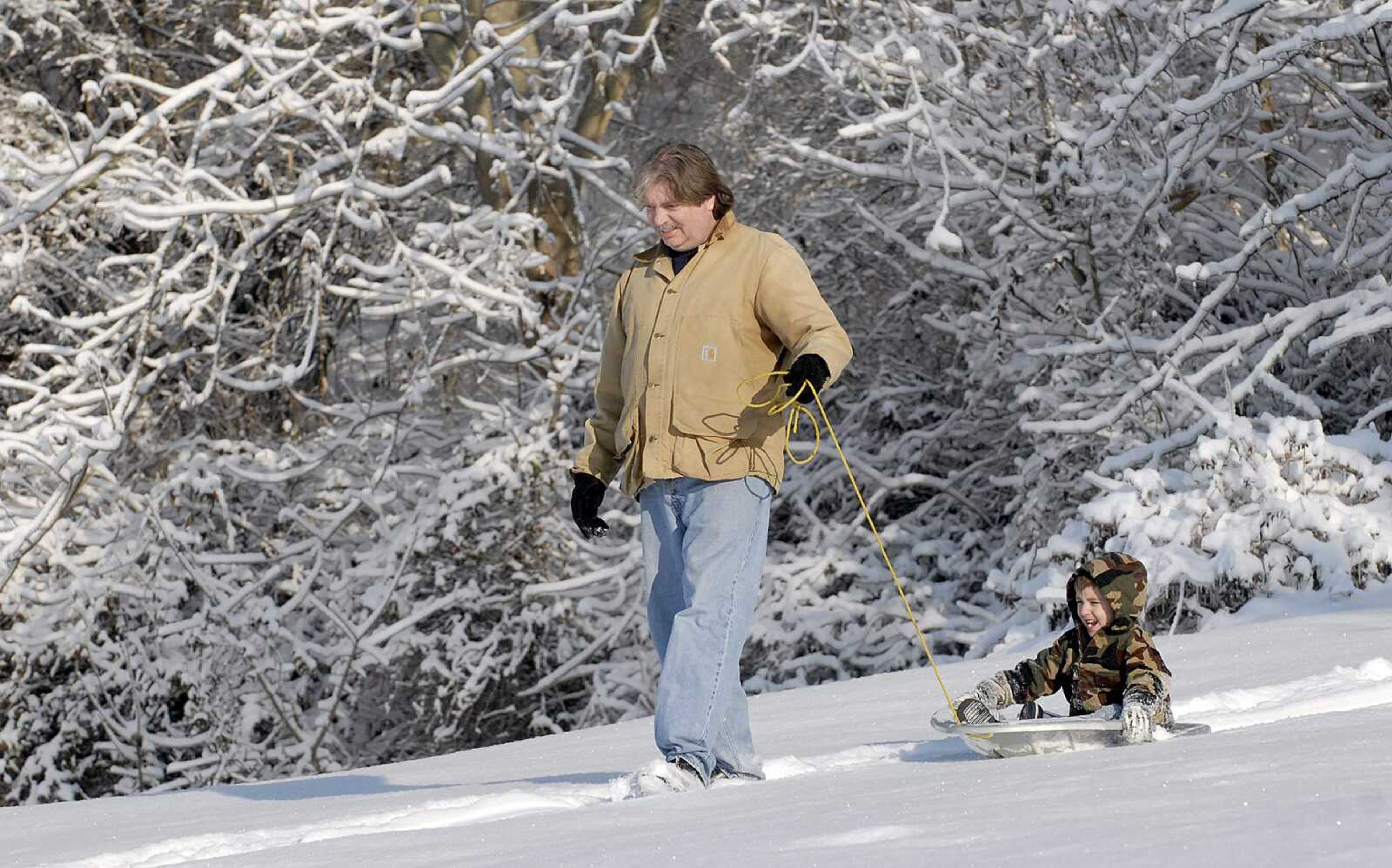 ELIZABETH DODD ~ edodd@semissourian.com
Reece Laray of Cape Girardeau pulls his grandson, Travis, 4, Wednesday morning. "I didn't want to come out here in the cold but he talked me into it," Laray said.