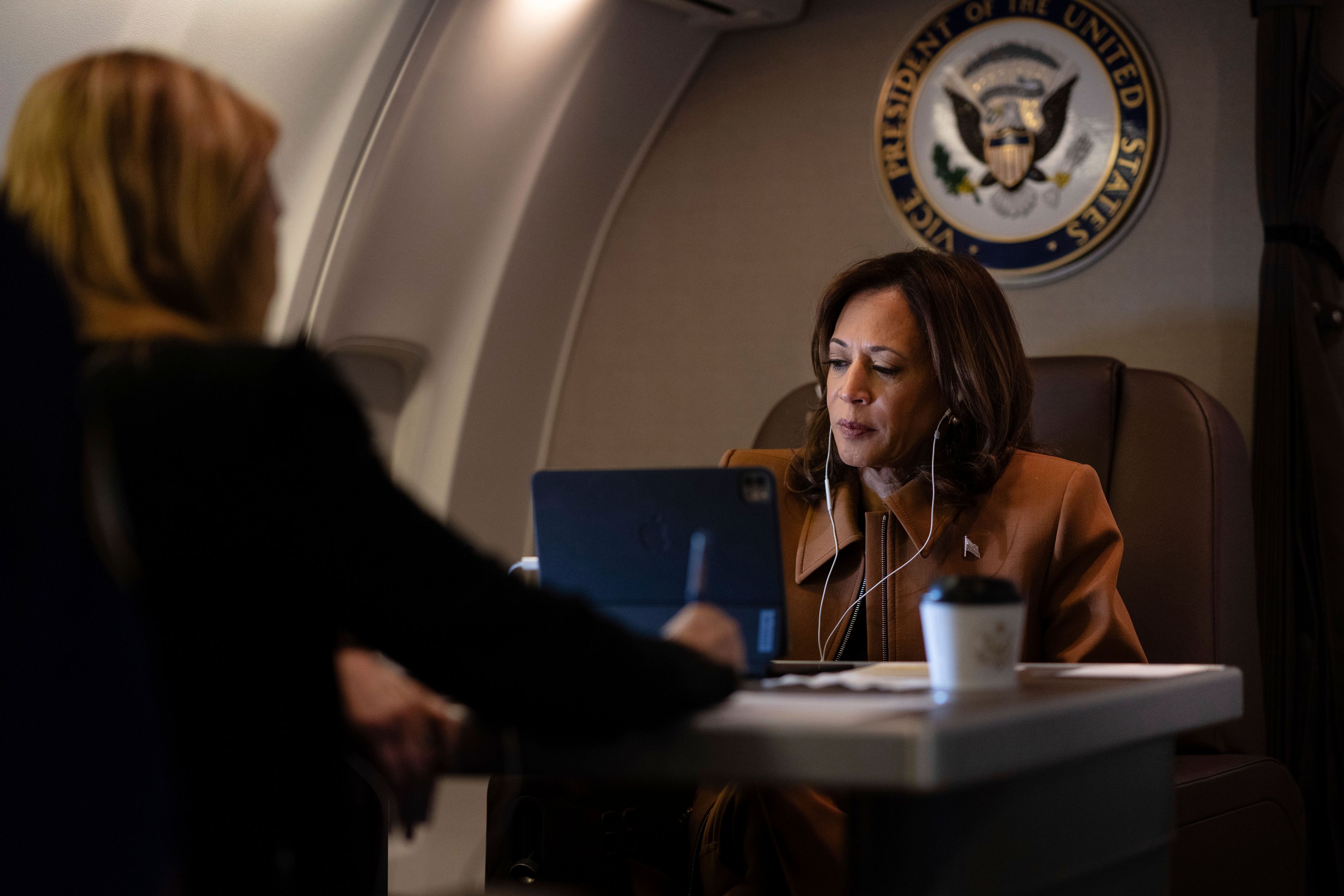 Democratic presidential nominee Vice President Kamala Harris works aboard Air Force Two while on a call en route from Texas to Michigan, Saturday, Oct. 26, 2024. (Erin Schaff/The New York Times via AP, Pool)