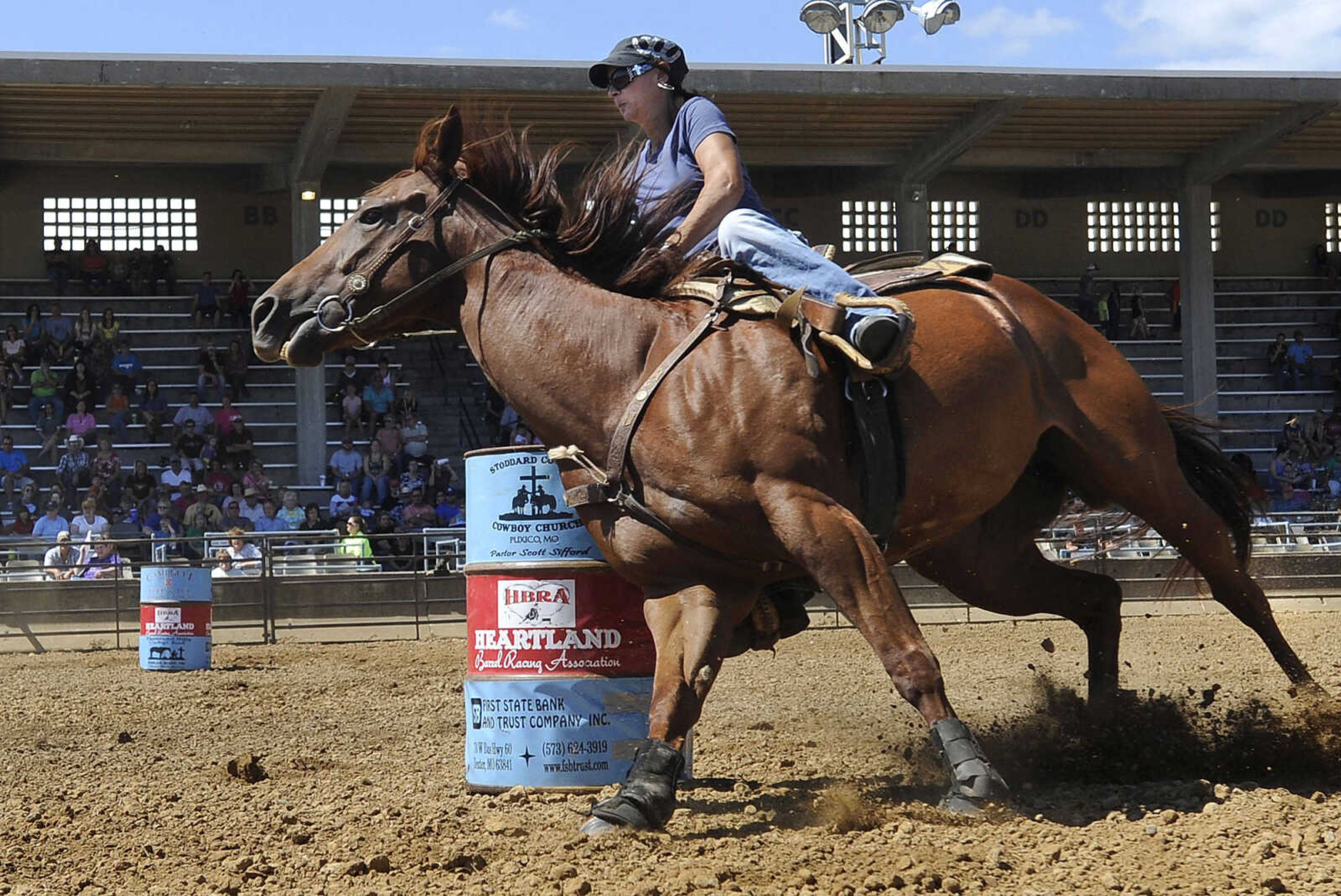 FRED LYNCH ~ flynch@semissourian.com
Monica Mason rides Red in the Heartland Barrel Racing Extravaganza event Sunday, Sept. 7, 2014 at the SEMO District Fair.