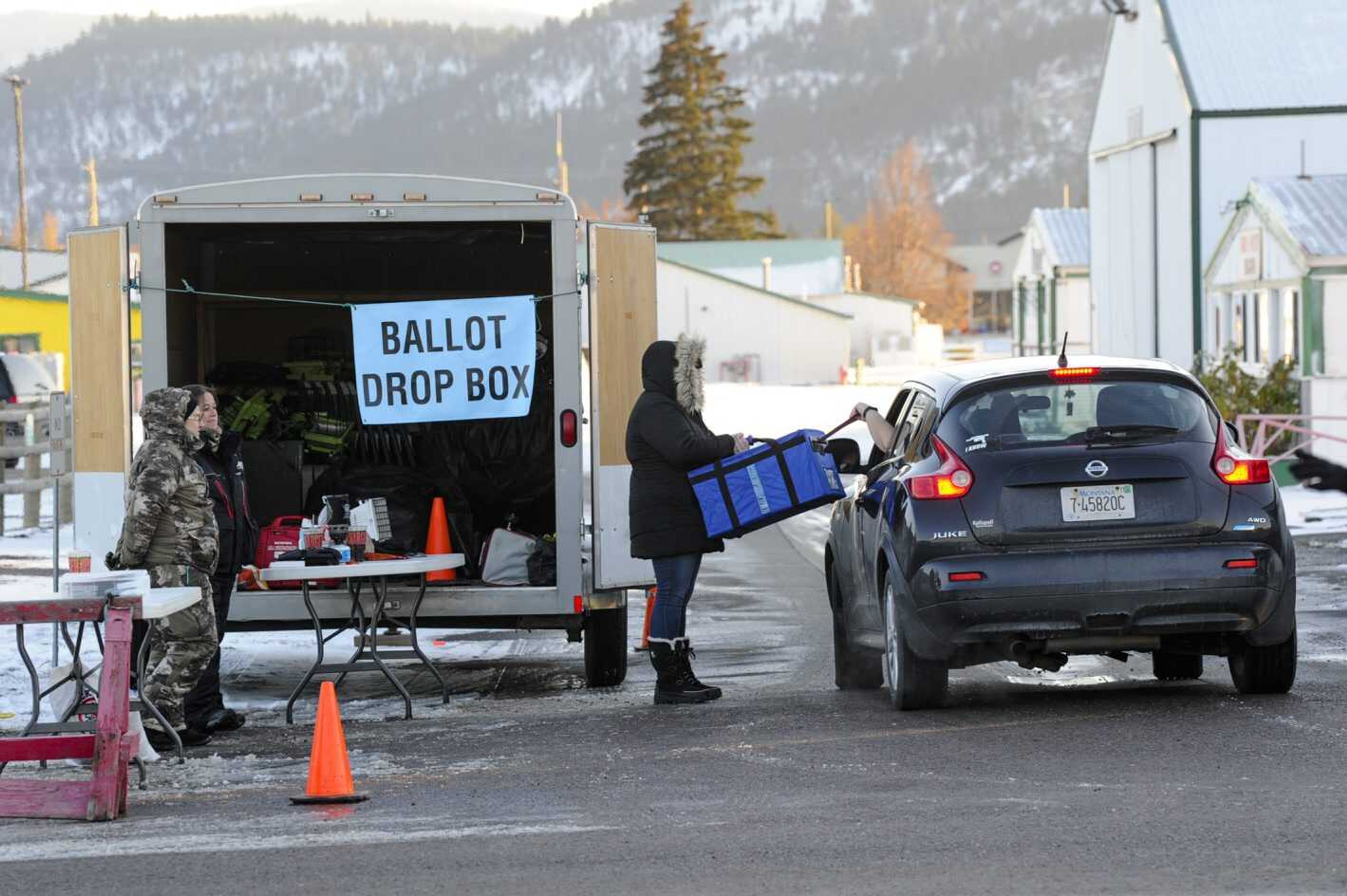 An absentee voter drops off their ballot outside the Flathead County Courthouse on Tuesday, Nov. 8, in Kalispell, Montana.