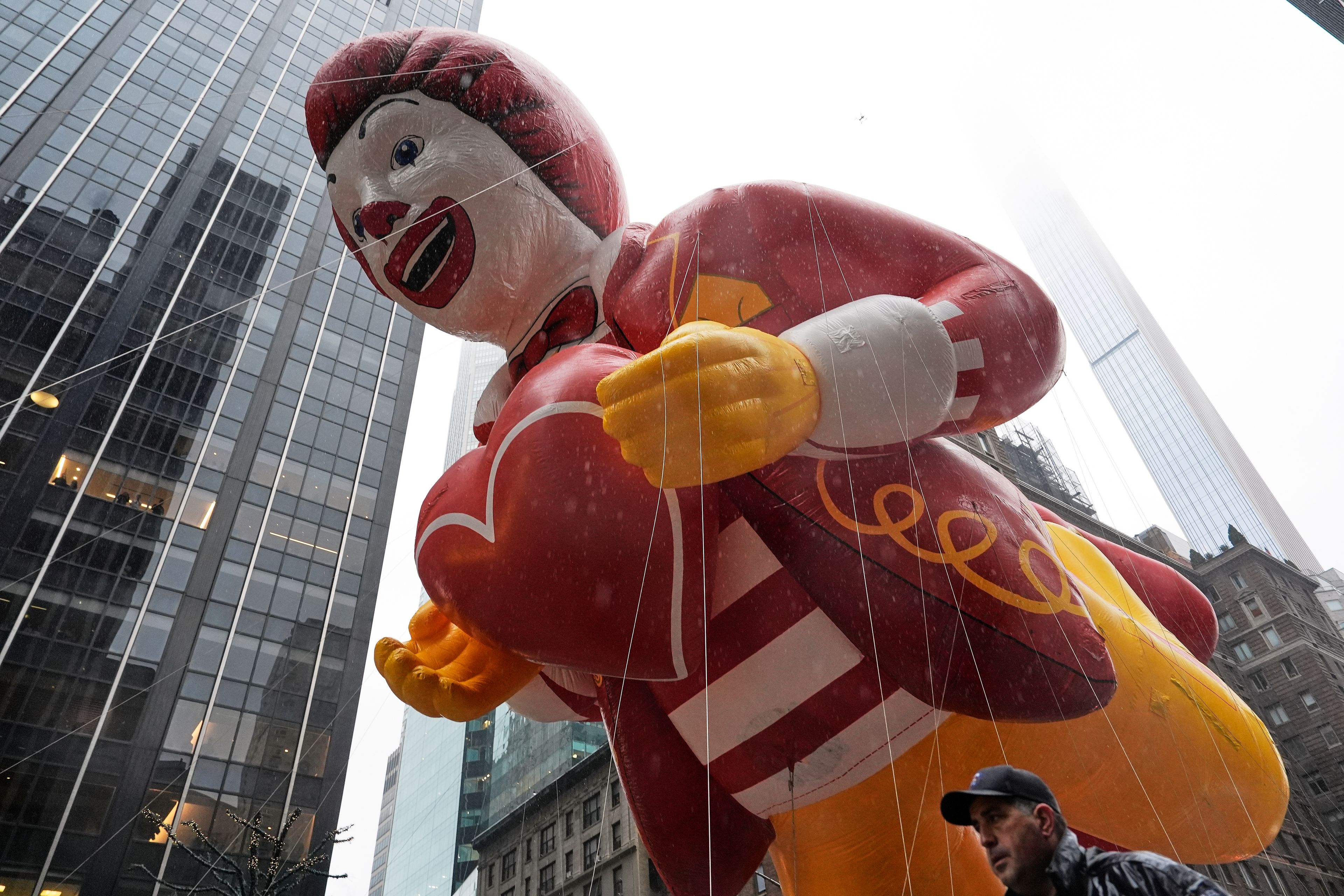 Handlers guide the Ronald McDonald balloon down Sixth Avenue during the Macy's Thanksgiving Day Parade, Thursday, Nov. 28, 2024, in New York. (AP Photo/Julia Demaree Nikhinson)