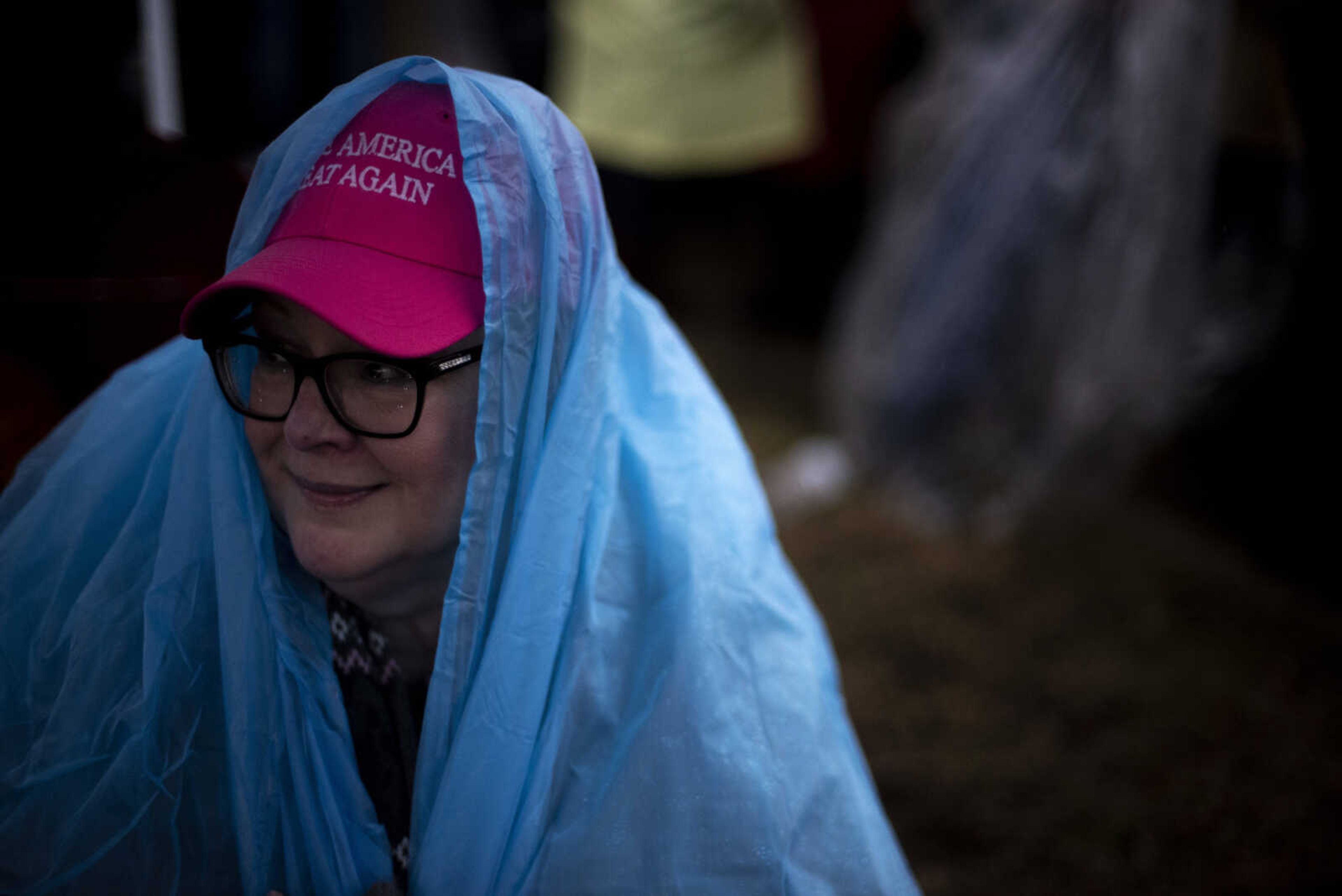 Cindy Jacquot, 56, of Illinois, seeks shelter under a tent from the rain while waiting for the for the Show Me Center doors to open Monday, Nov. 5, 2018, in Cape Girardeau.