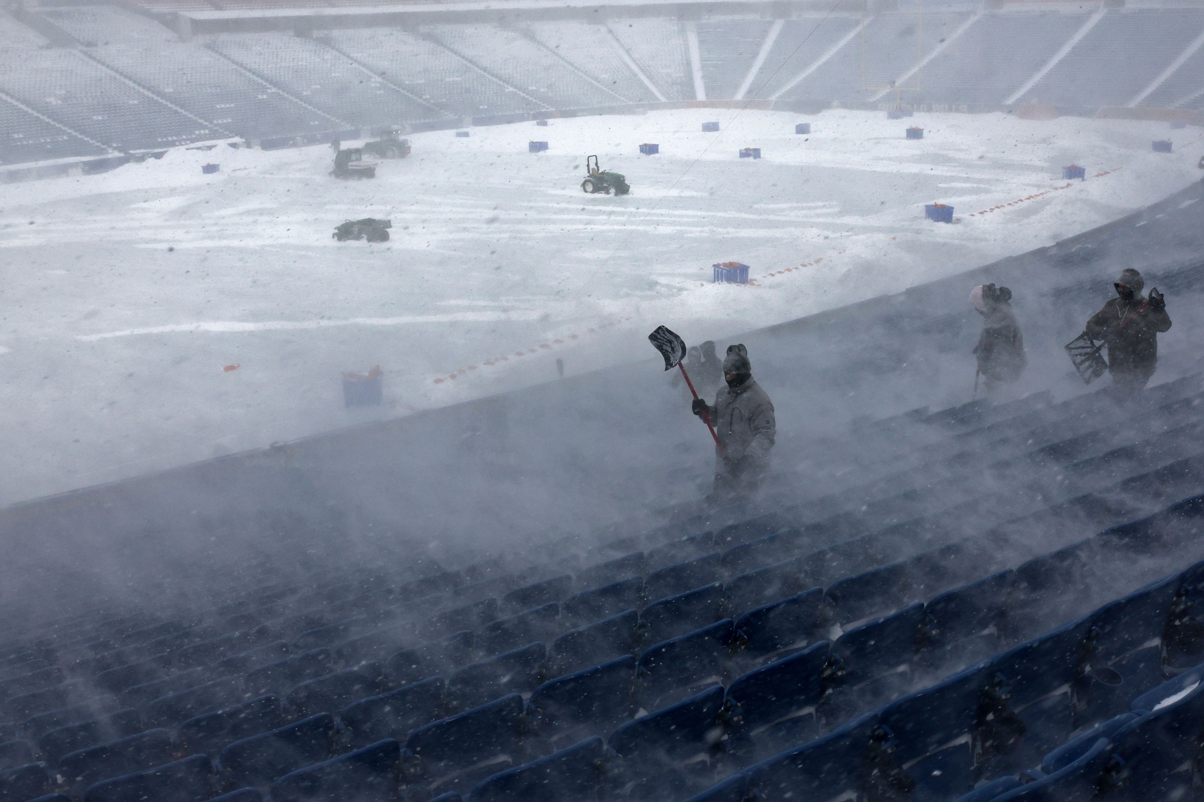 FILE - Workers remove snow from Highmark Stadium in Orchard Park, N.Y., Jan. 14, 2024. (AP Photo/Jeffrey T. Barnes, File)