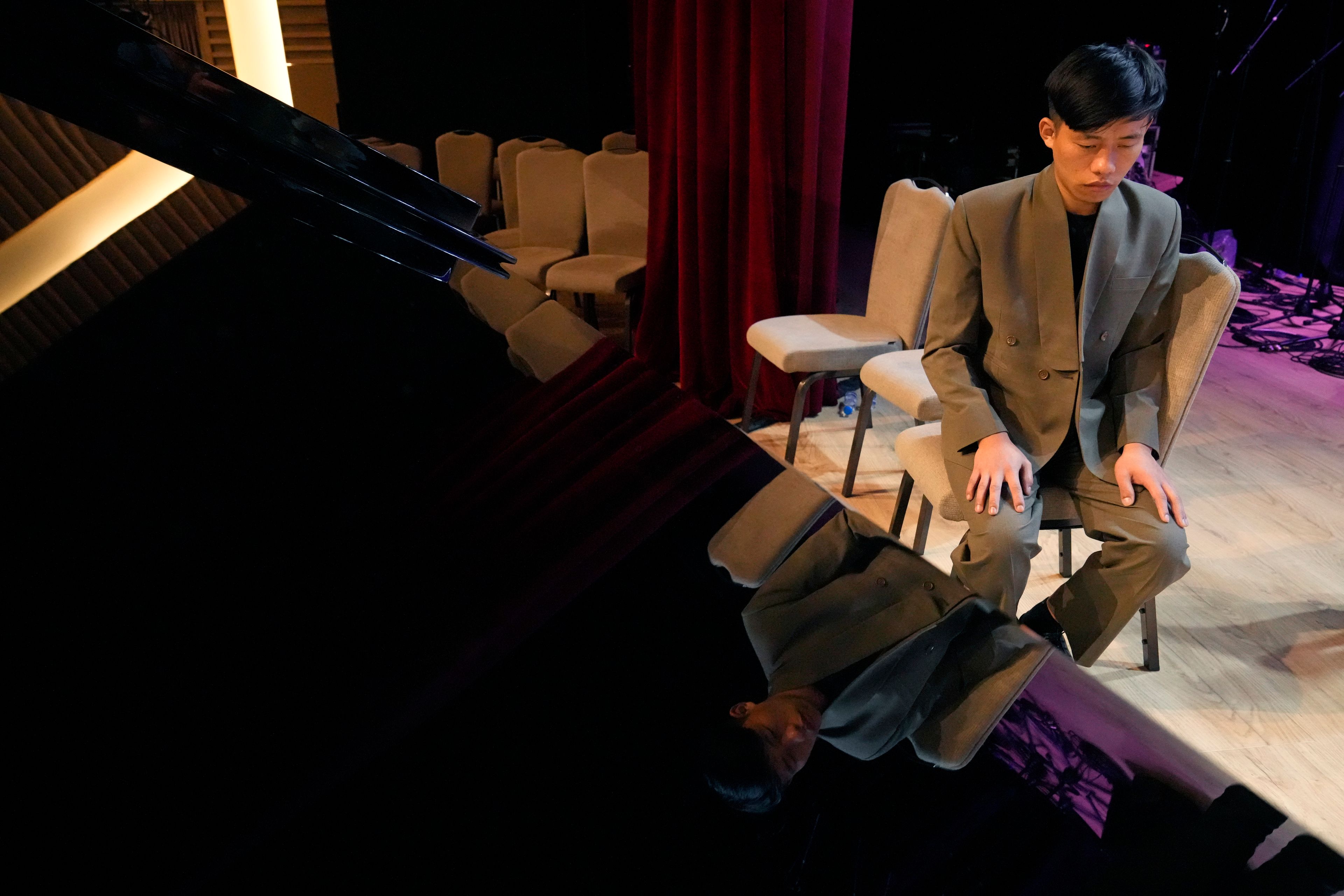 Takosangba Jamir, 27, a blind pianist, waits for his turn to rehearse during the two-day Brillante Piano Festival in Bengaluru, India, Sunday, Sept. 29, 2024. (AP Photo/Aijaz Rahi)