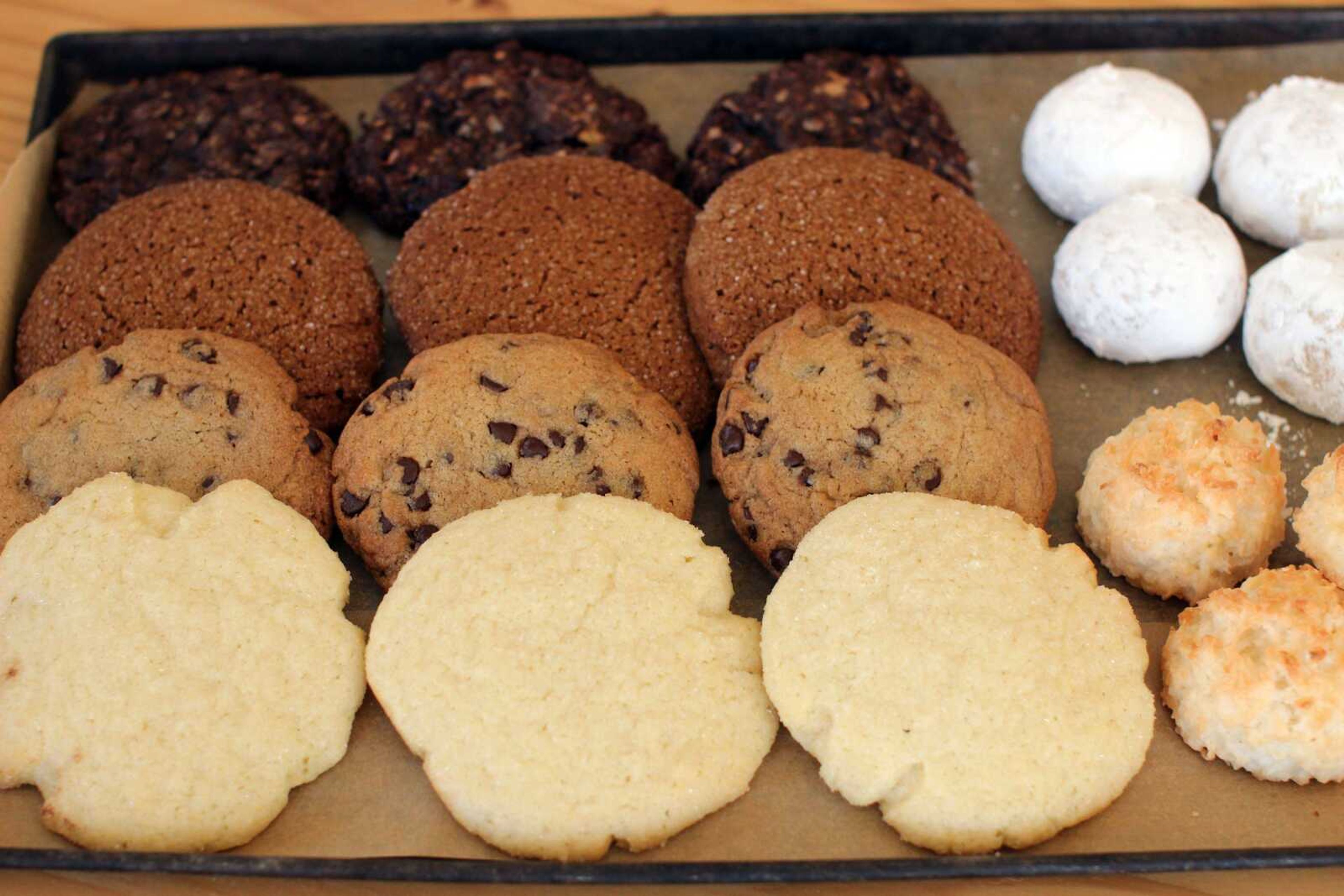 This photo shows an assortment of holiday cookies, clockwise from upper right: Russian tea cakes, coconut macaroons, sugar cookies, chocolate chip, molasses spice and chocolate oatmeal. There are tips and tricks professional bakers use that can benefit holiday baking at home. (AP Photo/Matthew Mead)