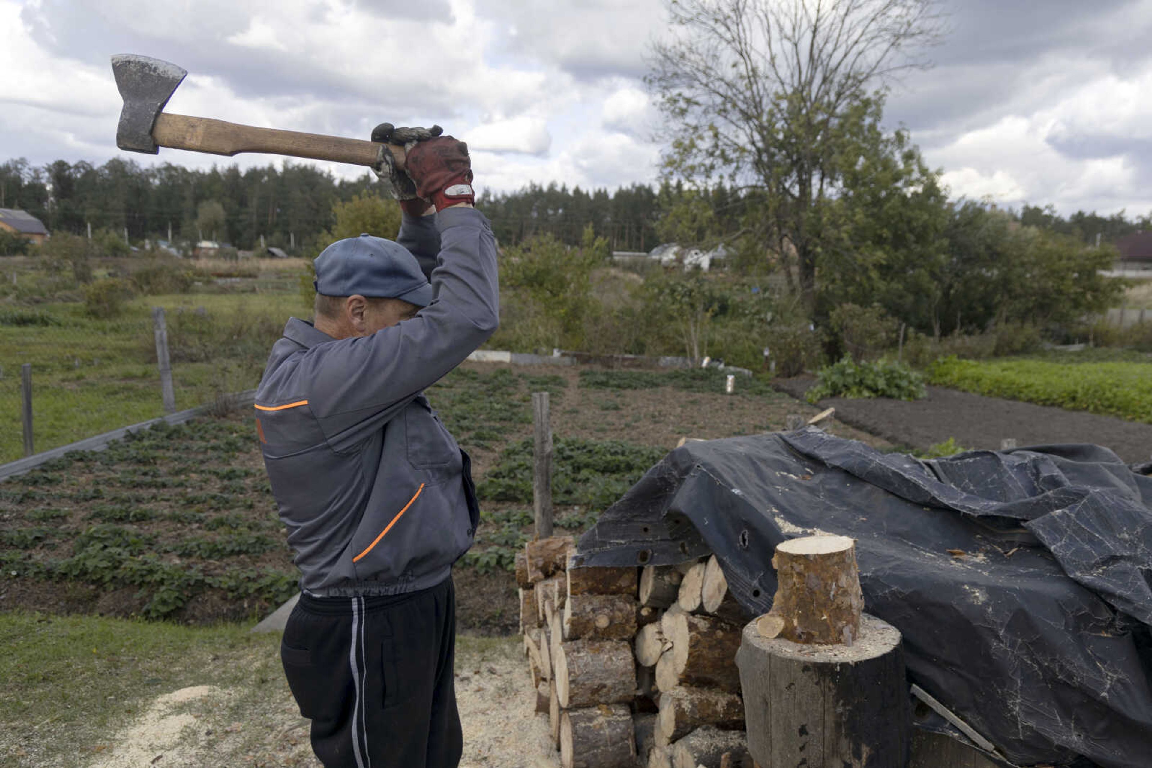 Anatoliy Fedorko, 56, chops wood Oct. 10 near his house in Moshchun, near Kyiv, Ukraine.