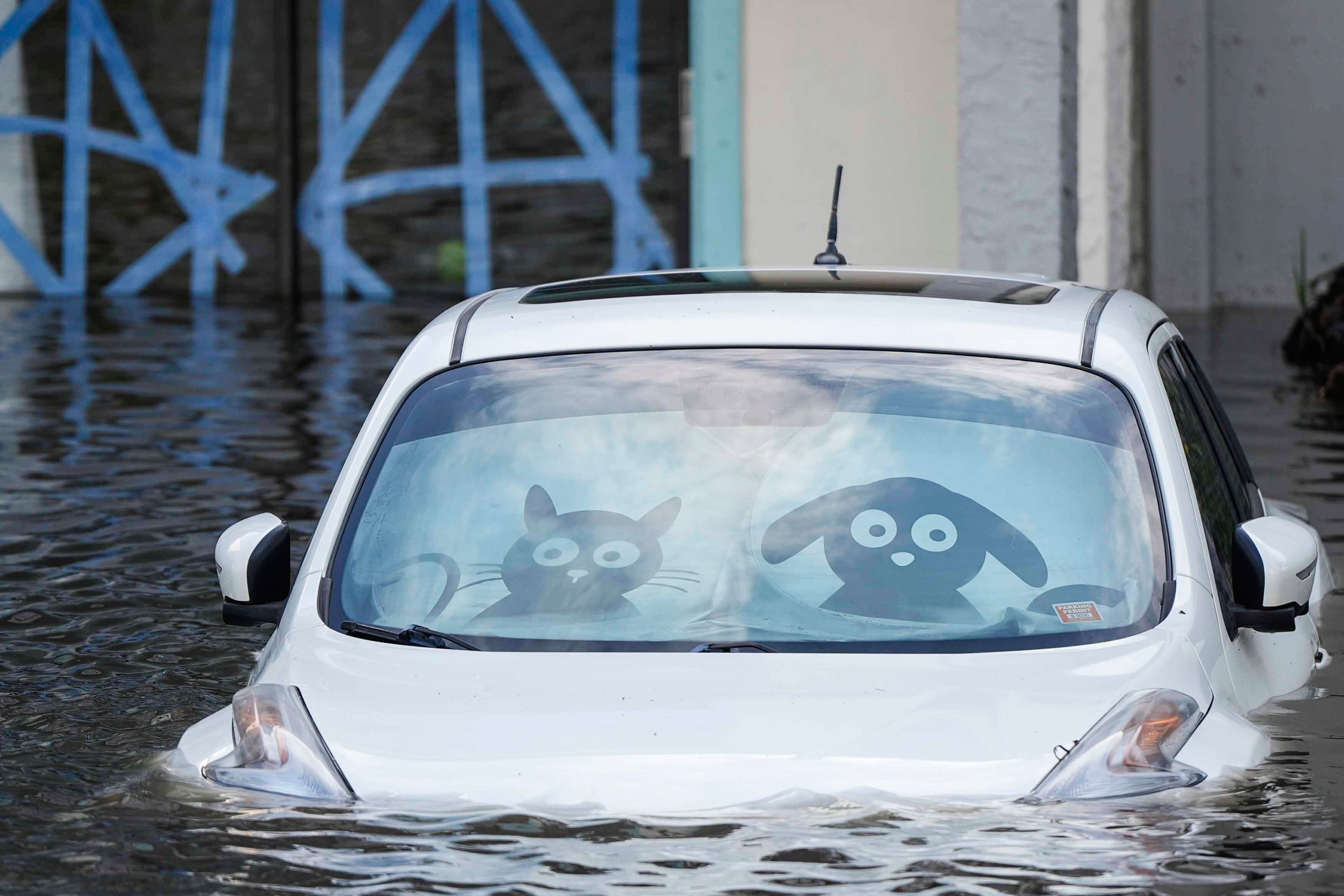 A car is submerged in floodwater at an apartment complex in the aftermath of Hurricane Milton, Thursday, Oct. 10, 2024, in Clearwater, Fla. (AP Photo/Mike Stewart)