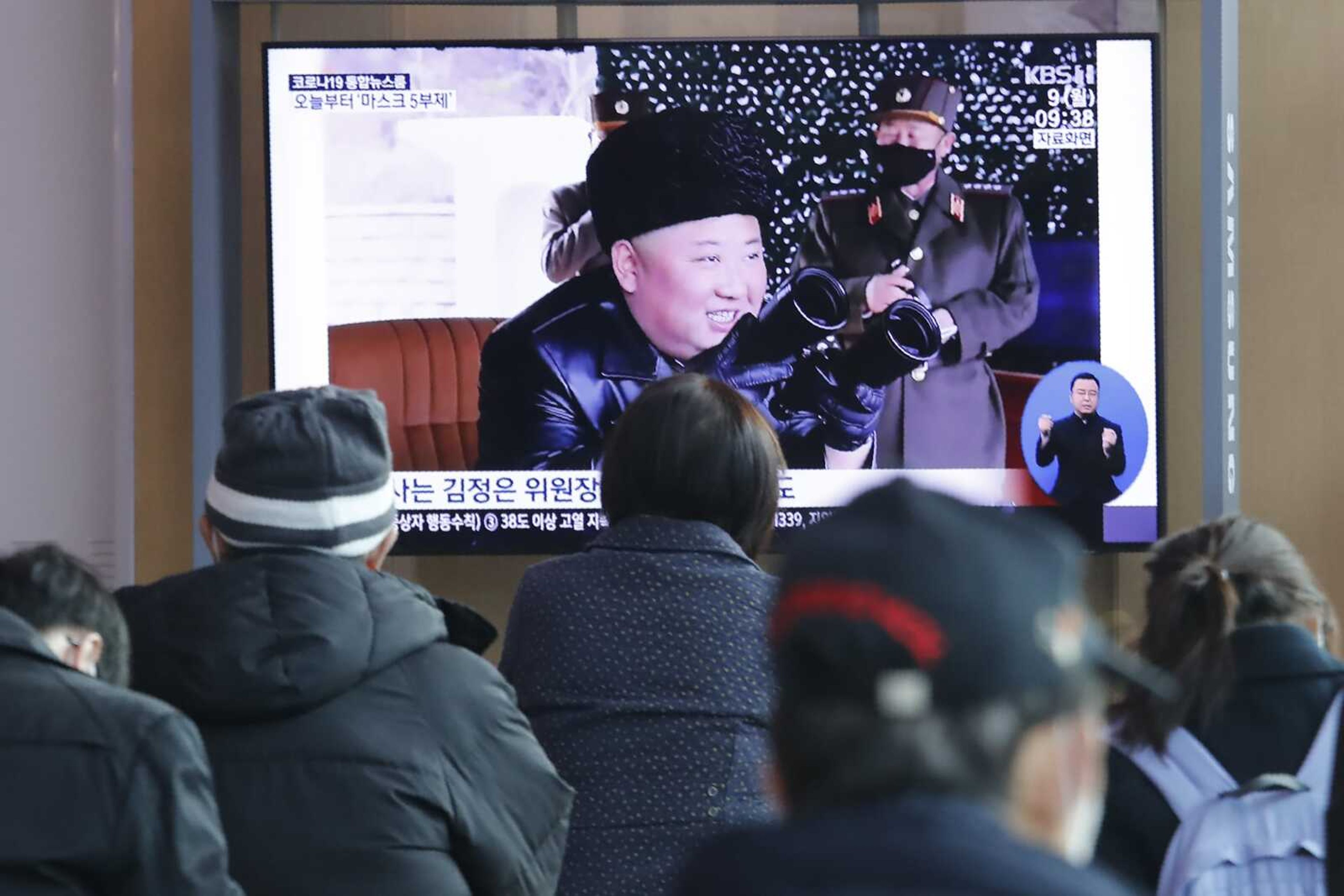 People watch a TV showing a file image of North Korean leader Kim Jong Un during a news program today at the Seoul Railway Station in Seoul, South Korea. North Korea fired three unidentified projectiles off its east coast today, South Korea's military said, two days after the North threatened to take "momentous" action to protest outside condemnation over its earlier live-fire exercises.