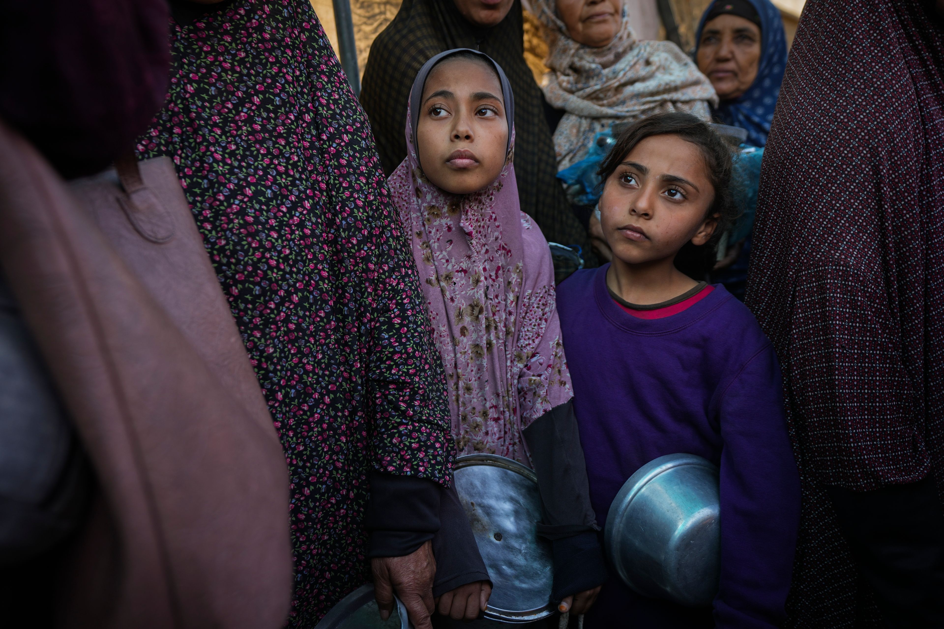 Palestinian children queue at a food distribution kitchen in Deir al-Balah, Gaza Strip, Friday Nov. 22, 2024. (AP Photo/Abdel Kareem Hana)