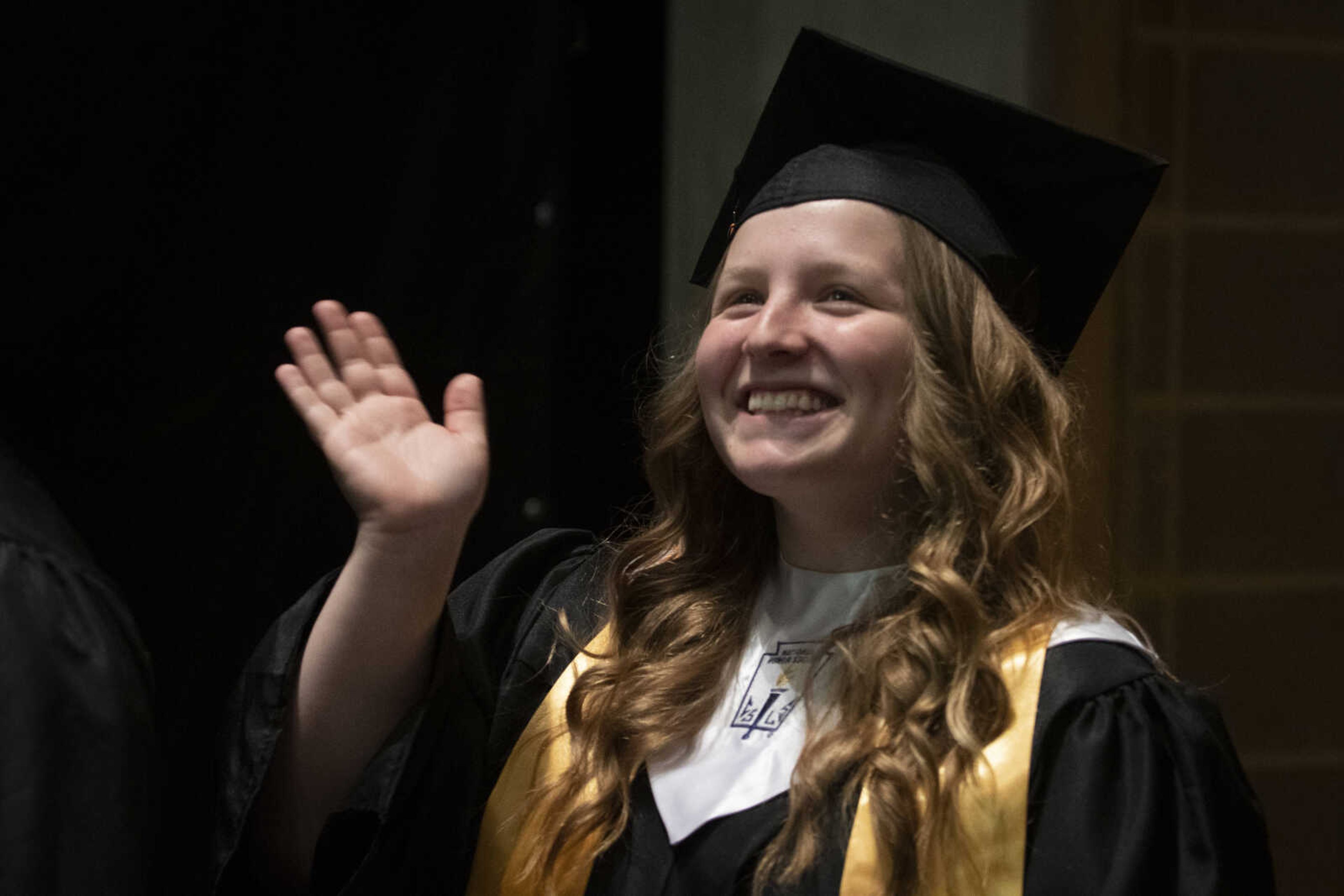 Cape Central's Ashley Stone waves before walking in the processional during Cape Central High School's Class of 2019 Commencement on Sunday, May 12, 2019, at the Show Me Center in Cape Girardeau.