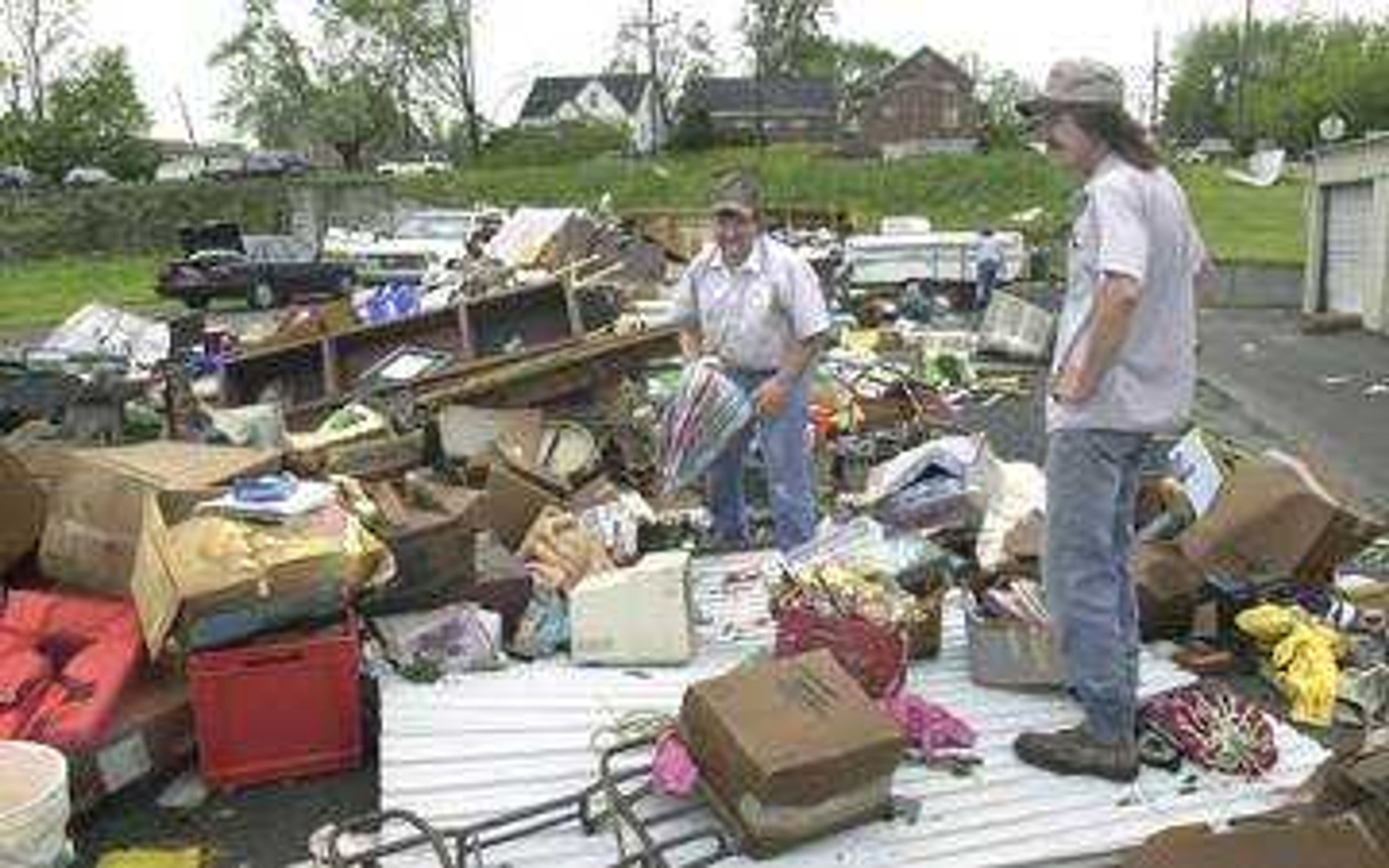 Chris Webb, left, helped his friend Randy Norris sort through his rain soaked belongings after Tuesday's tornado destroyed the storage facility located along East Adams Street in Jackson.