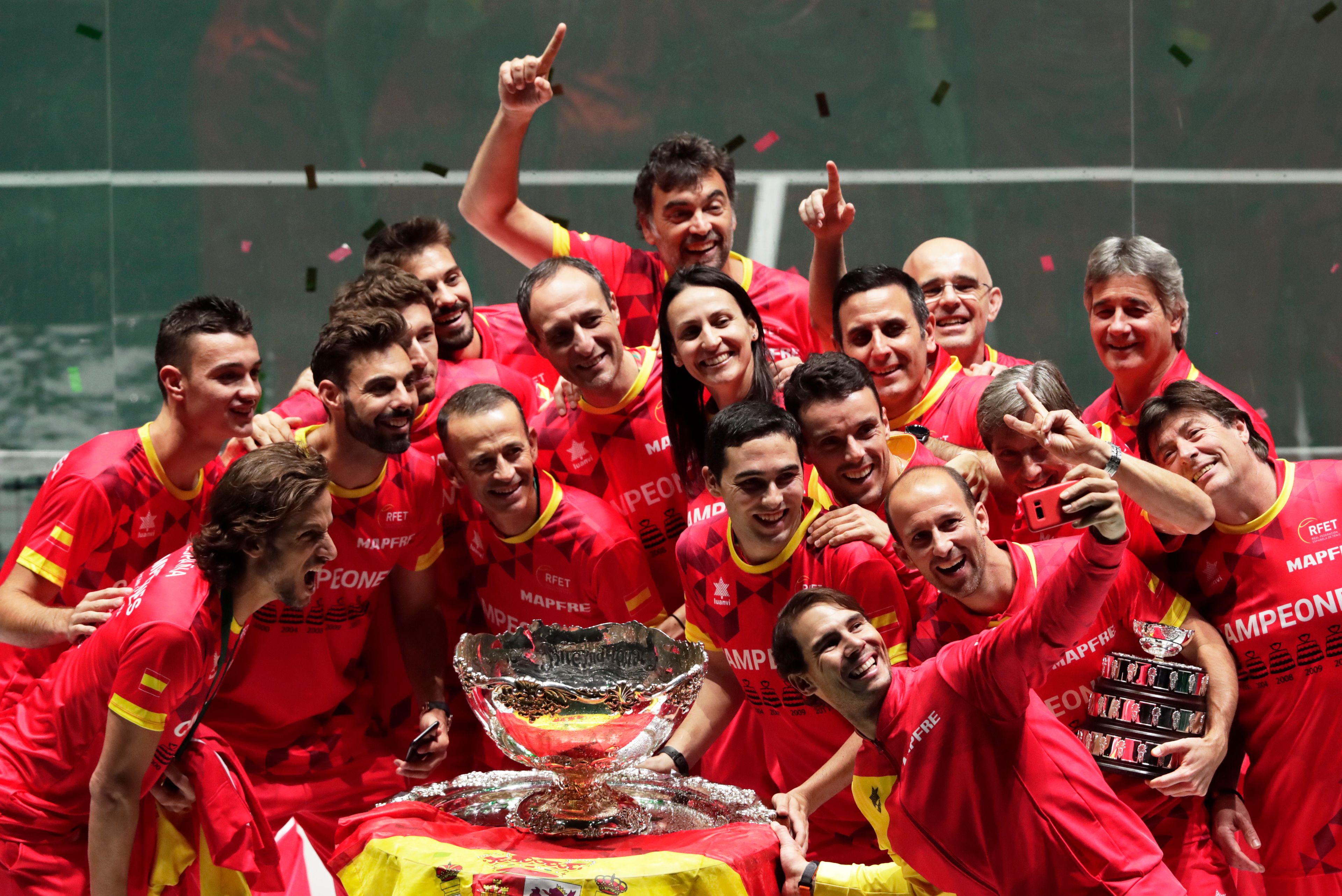 FILE - Spain's Rafael Nadal, foreground, takes a selfie with fellow players and team staff posing with the trophy after Spain defeated Canada 2-0 to win the Davis Cup final in Madrid, Spain, Sunday, Nov. 24, 2019. (AP Photo/Bernat Armangue, File)