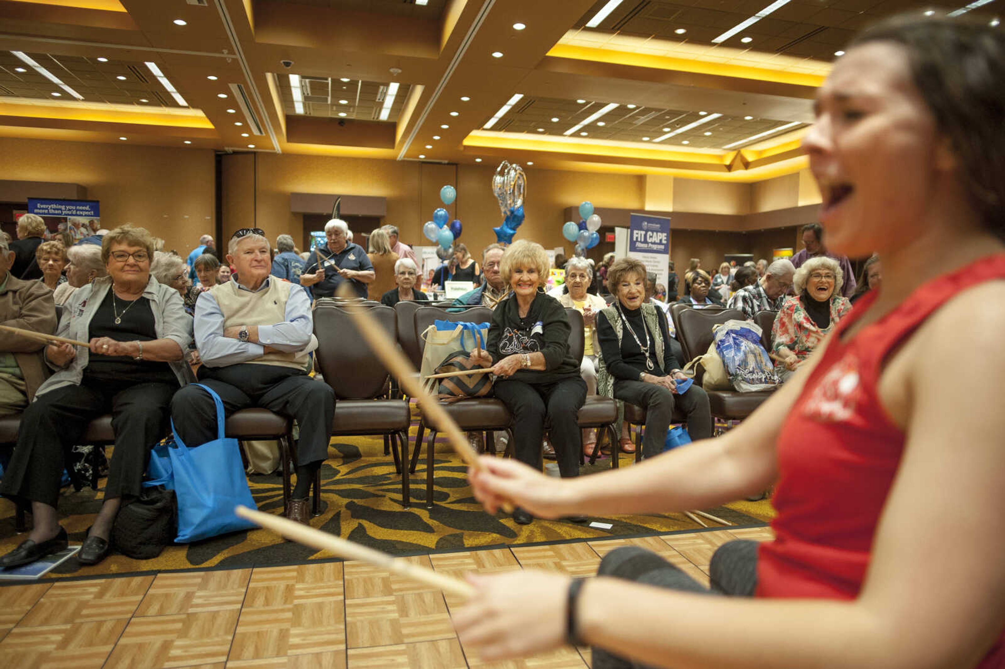 Attendees drum along to a cardio routine during the TBY Active Living Expo Wednesday, Oct. 9, 2019, at the Isle Casino in Cape Girardeau.