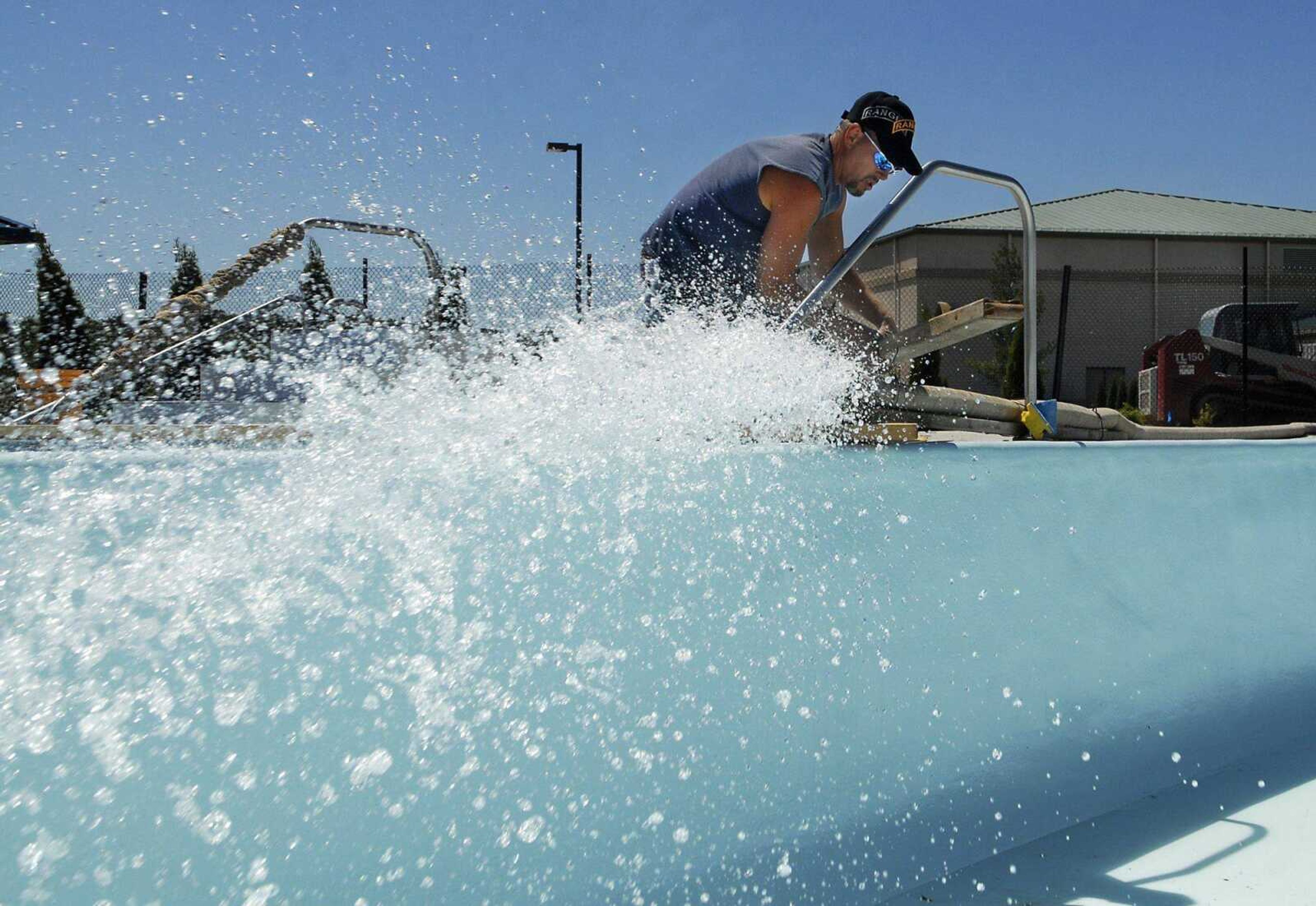 Fred Moore of Westport Pools monitors the hose used to fill the lazy river Saturday at the new Cape Splash Family Aquatic Center. The 700-foot-long-by-11-foot-wide river will hold about 200,000 gallons of water and take between 10 and 20 hours to fill using the hose. (KRISTIN EBERTS)