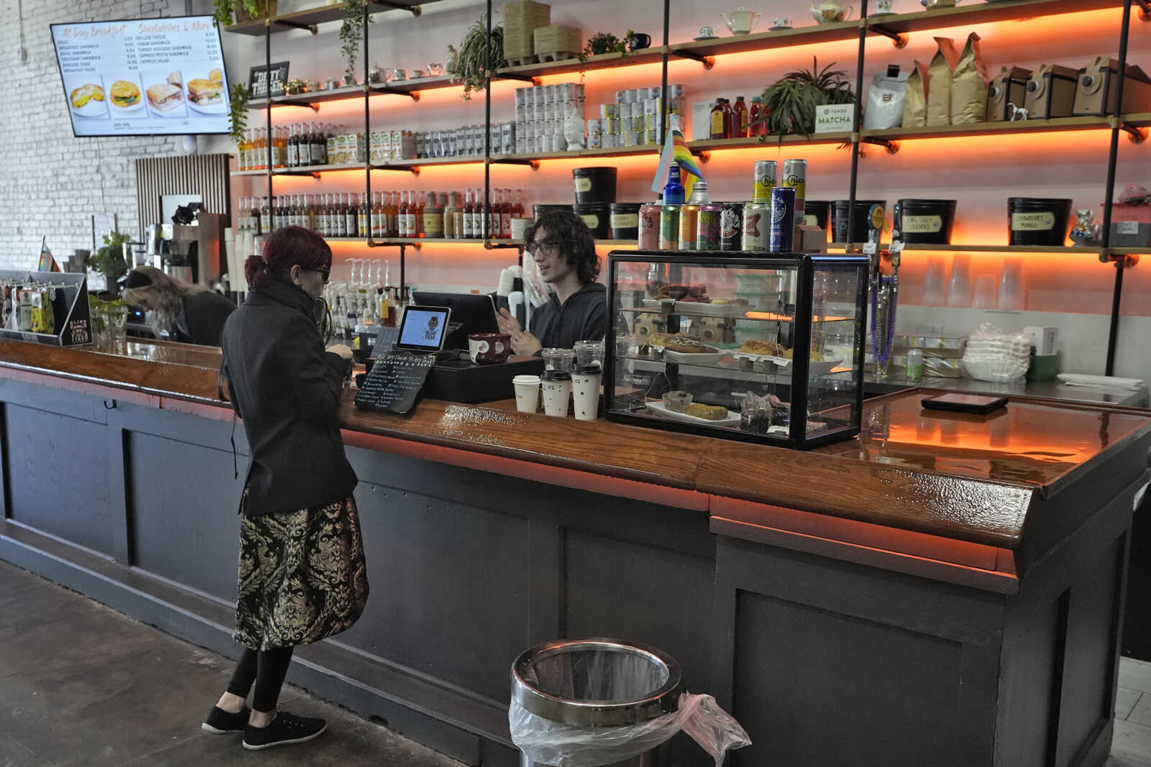 FILE - A customer buys a cup of coffee at the Blind Tiger Cafe on Jan. 10, 2024, in Tampa, Fla. On Tuesday, the Labor Department issues its report on inflation at the consumer level in January. (AP Photo/Chris O Meara, File)