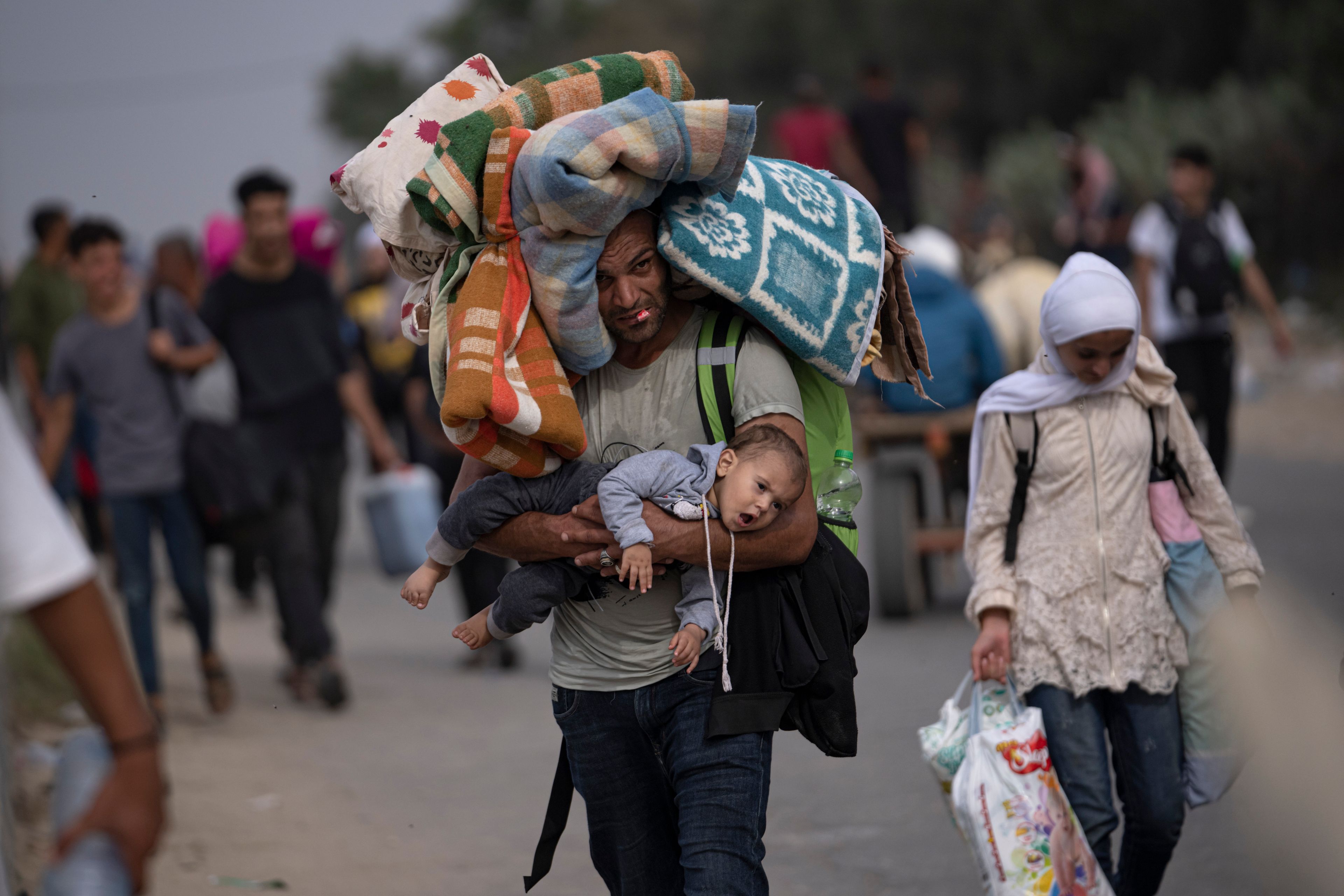 FILE - Palestinians flee to the southern Gaza Strip on Salah al-Din Street in Bureij, Gaza Strip, Saturday, Nov. 11, 2023. (AP Photo/Fatima Shbair, File)