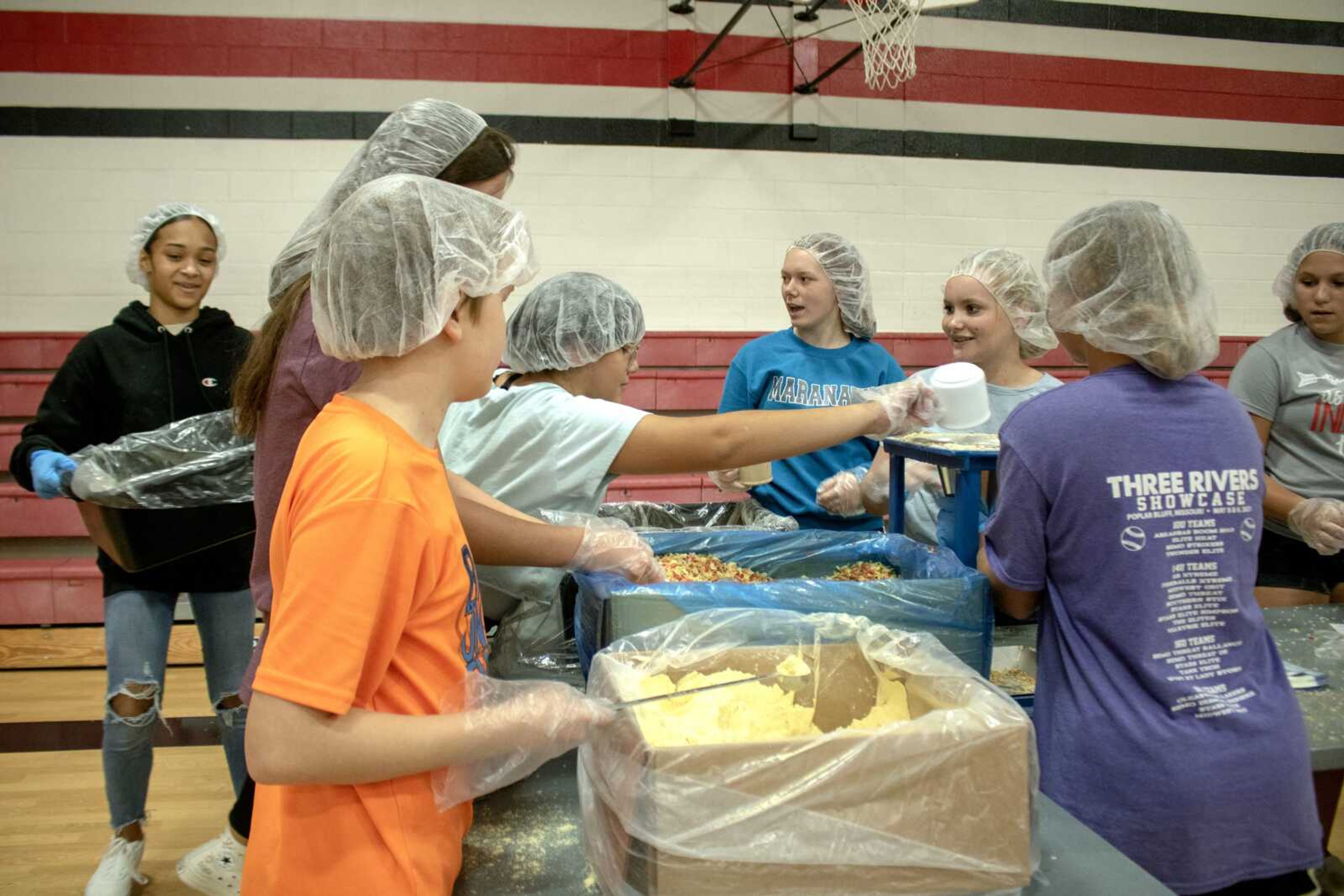 Jackson Junior High students work to fill bags of food Thursday at a service event for Feed My Starving Children.