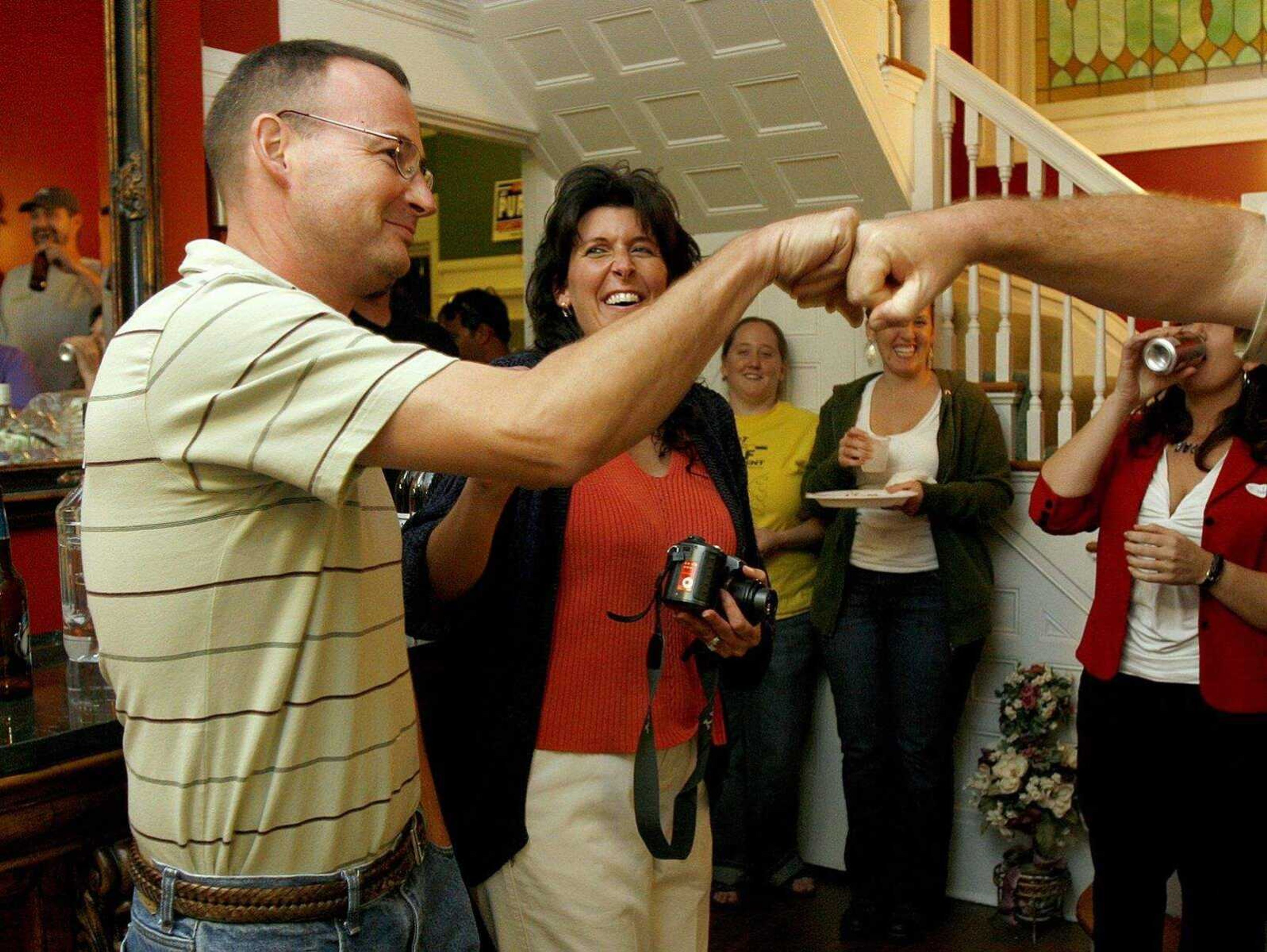 ELIZABETH DODD ~ edodd@semissourian.com
Jay Purcell, running for Cape Girardeau County commissioner hits knuckles with a friend after a small acceptance speech at his home in Cape Girardeau with friends and family Tuesday night.