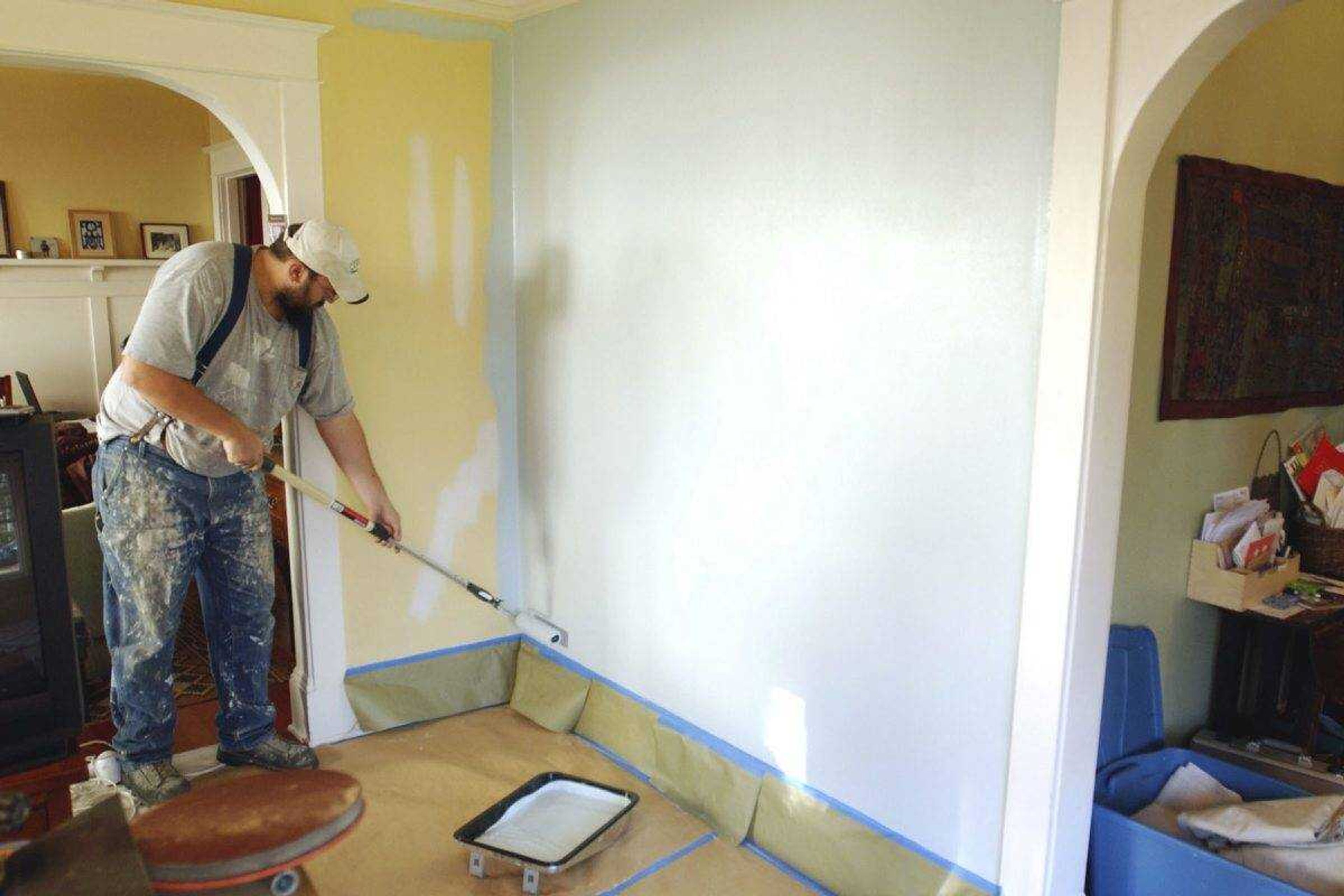 Painting contractor Andrew Lohr finishes the first coat on his living room wall Dec. 5, 2008, in Portland, Oregon. Home improvements can rejuvenate a stale dwelling. A fresh coat of paint on the walls can make for a quick makeover.