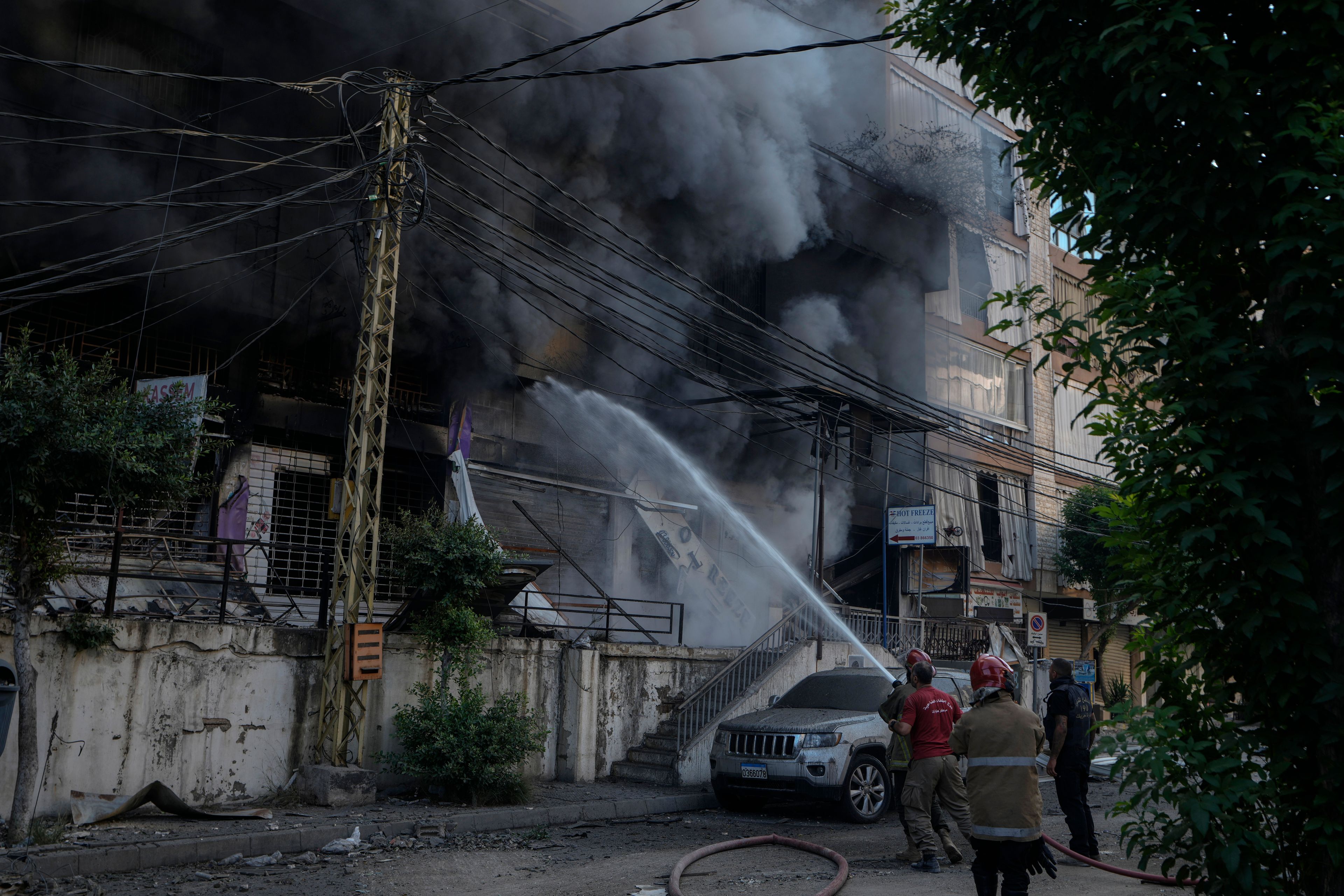 Firefighters extinguish a fire at the site of an Israeli airstrike in Dahiyeh, Beirut, Lebanon, Sunday, Oct. 6, 2024. (AP Photo/Bilal Hussein)