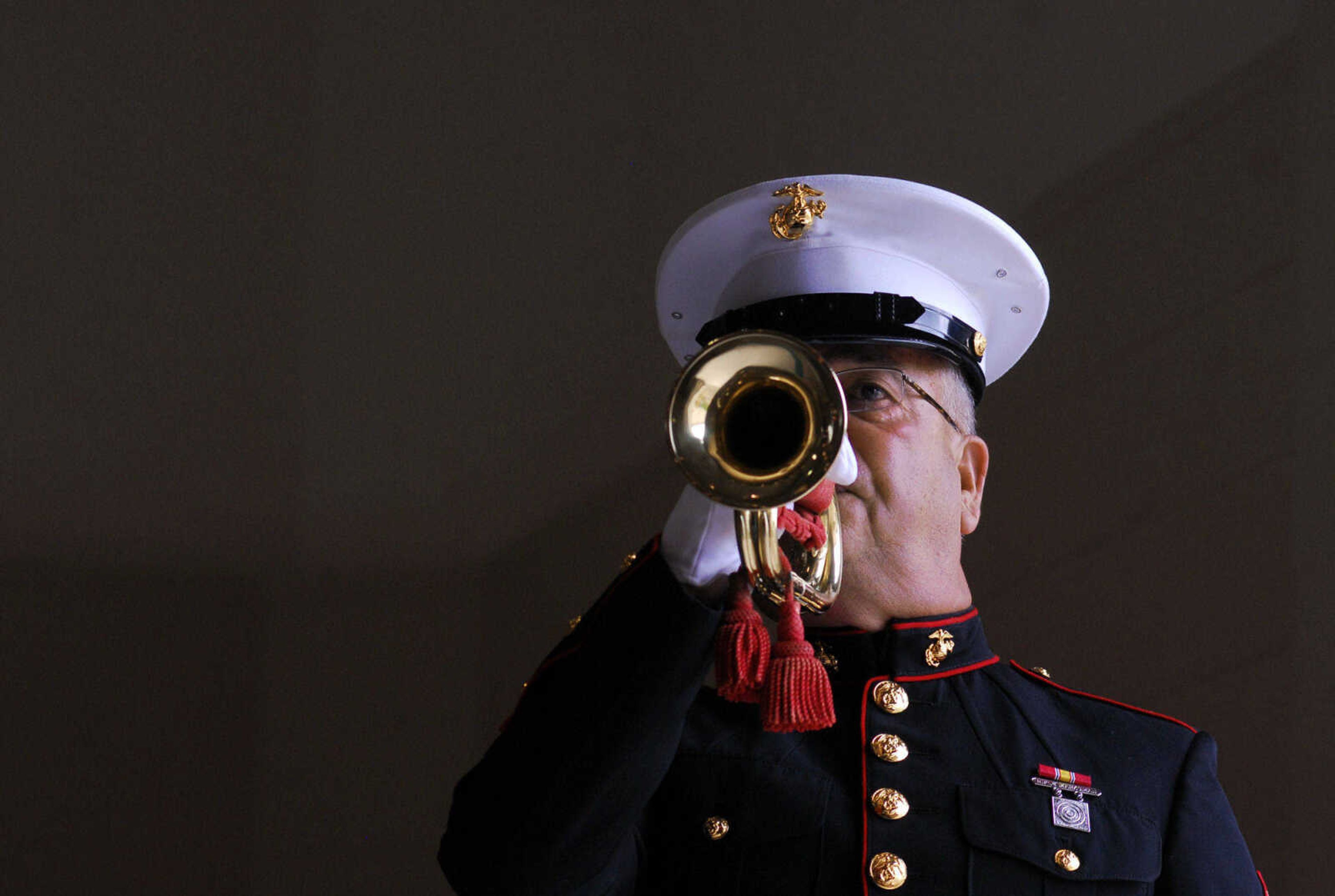 LAURA SIMON~lsimon@semissourian.com
Marine Corp Sr. Vice Commandant Bob Francis plays "Taps" Monday, May 31, 2010 during the Memorial Day Program at the Osage Community Centre.