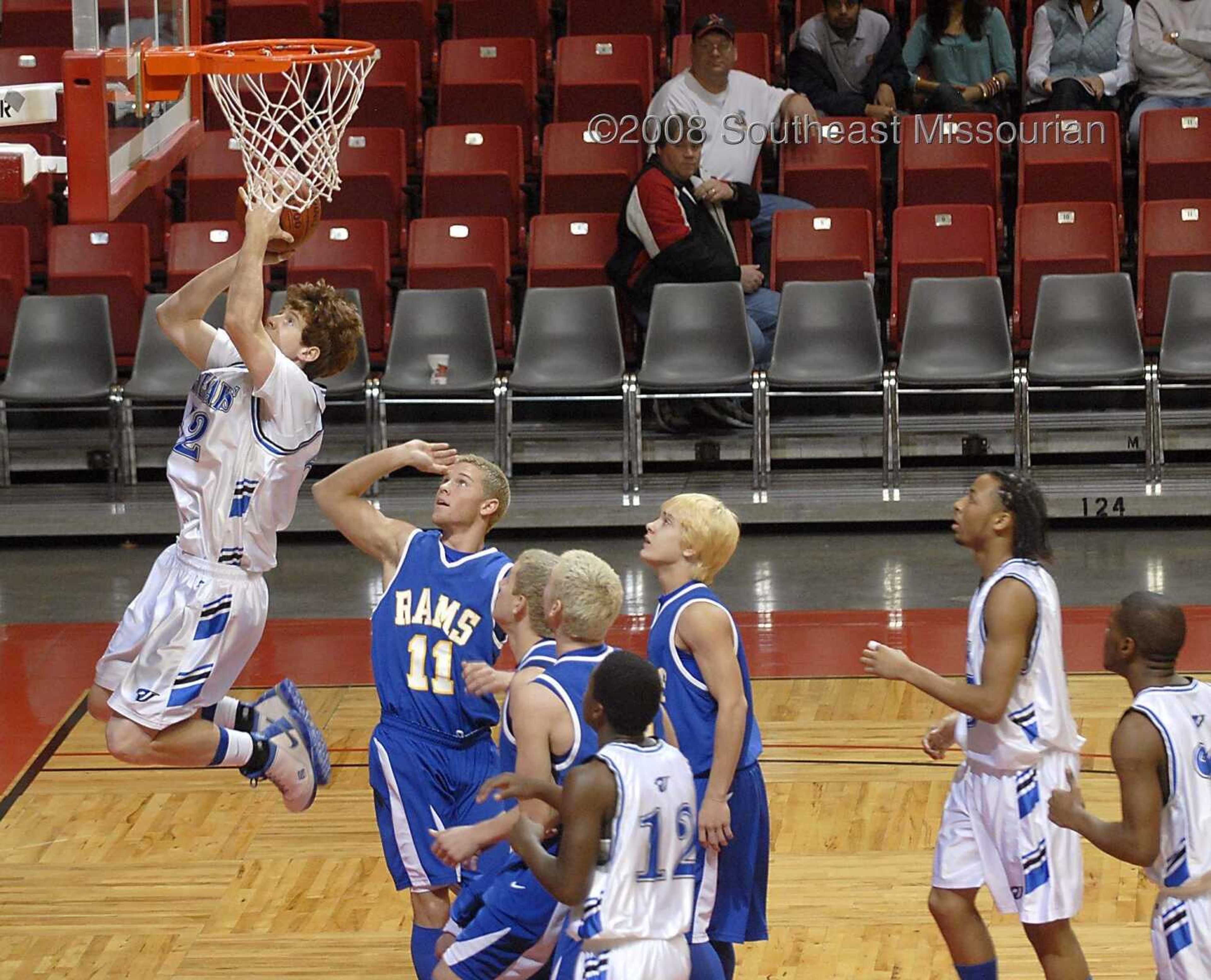 KIT DOYLE ~ kdoyle@semissourian.com
Charleston's Chase McClendon hangs above Scott City defenders while scoring two points Friday, December 26, 2008, in the first round of the Southeast Missourian Christmas Tournament at the Show Me Center.